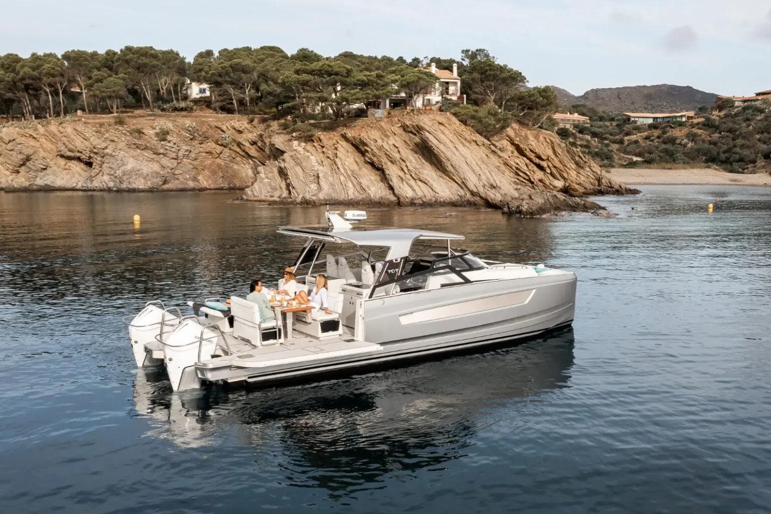 Luxury YOT 36 boat cruising near rocky coastline, 2026 model.