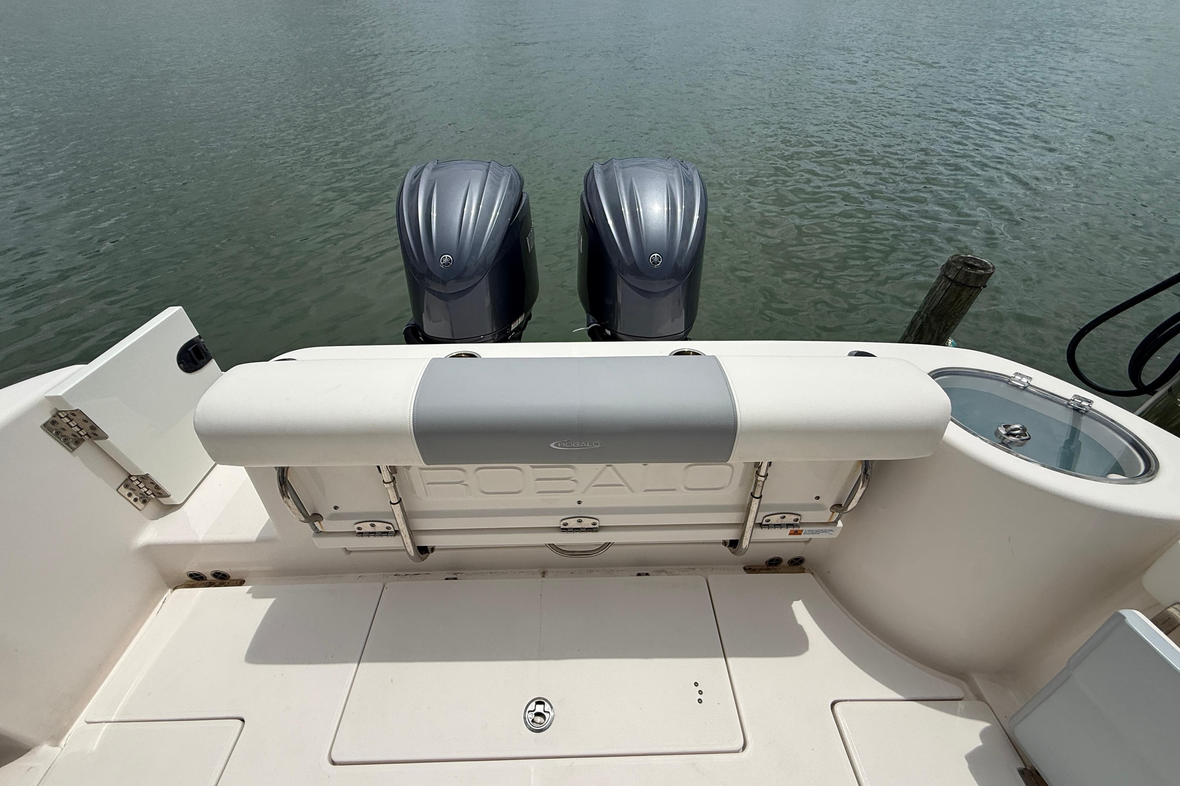 2022 Robalo R302 Center Console boat with dual engines on calm water.