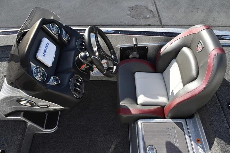 2026 Triton 179 TrX boat cockpit with steering wheel and cushioned seat.