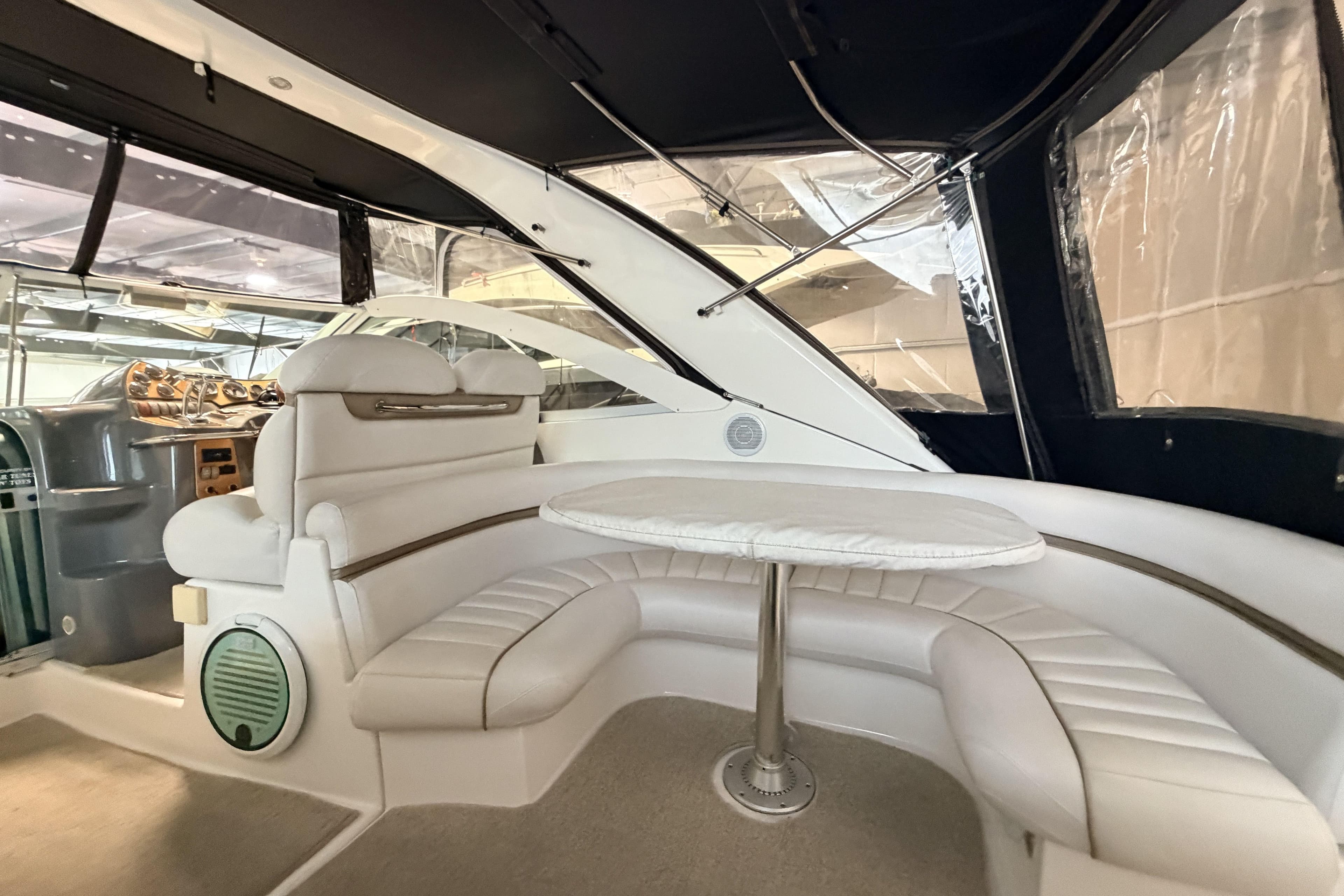 Interior of a 2006 Doral Boca Grande yacht with white seating and table.