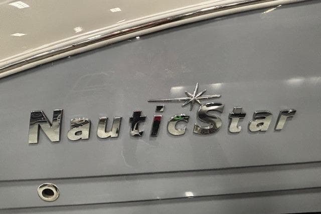 2023 NauticStar 243DC Sport Deck boat logo on gray hull.