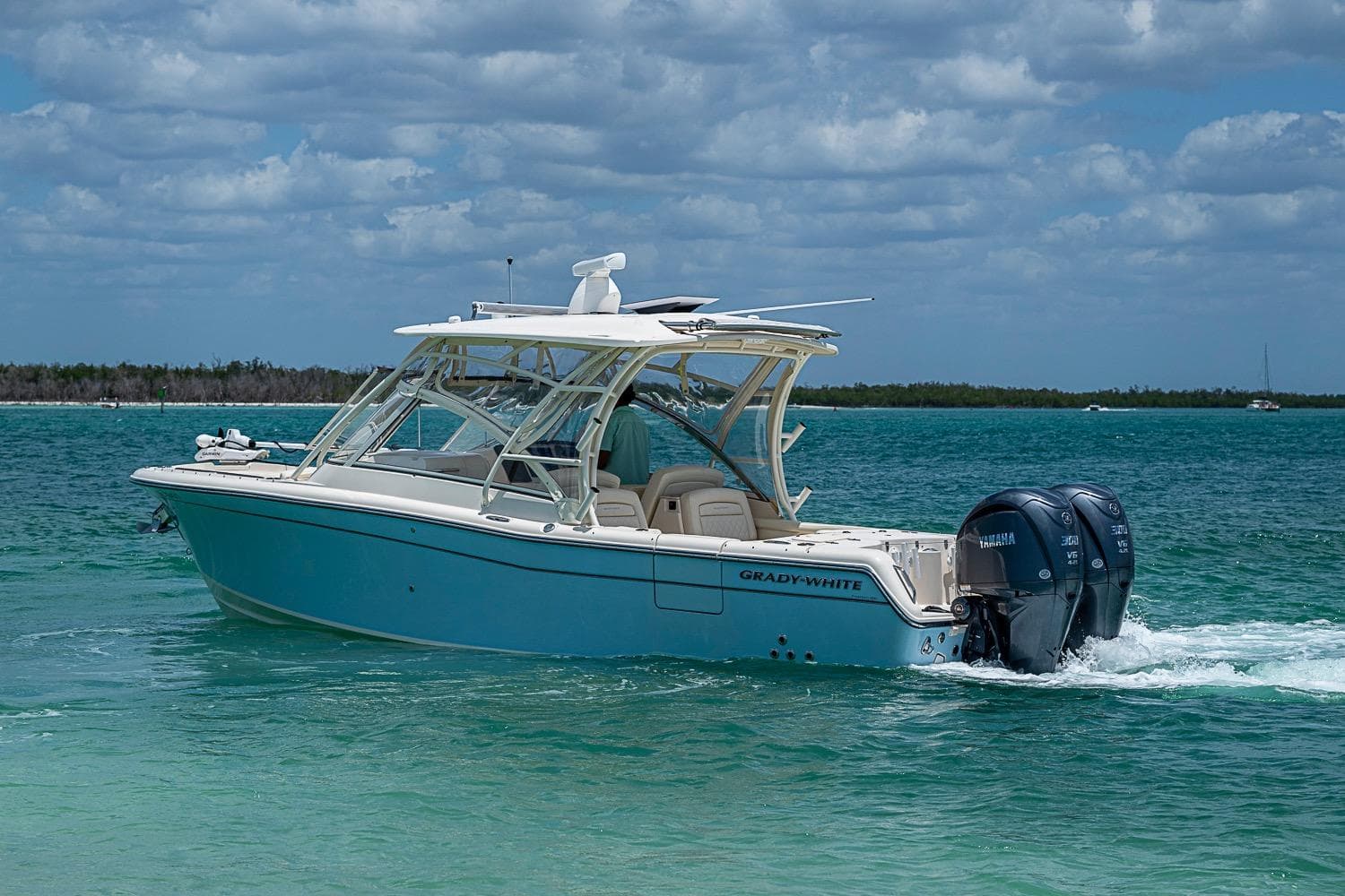 2022 Grady-White Freedom 285 boat cruising on clear blue water.