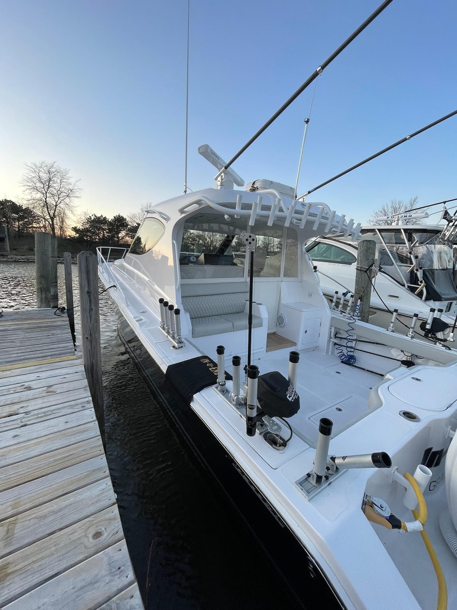 2021 Jupiter 41 SB boat docked at marina, featuring sleek design and fishing equipment.