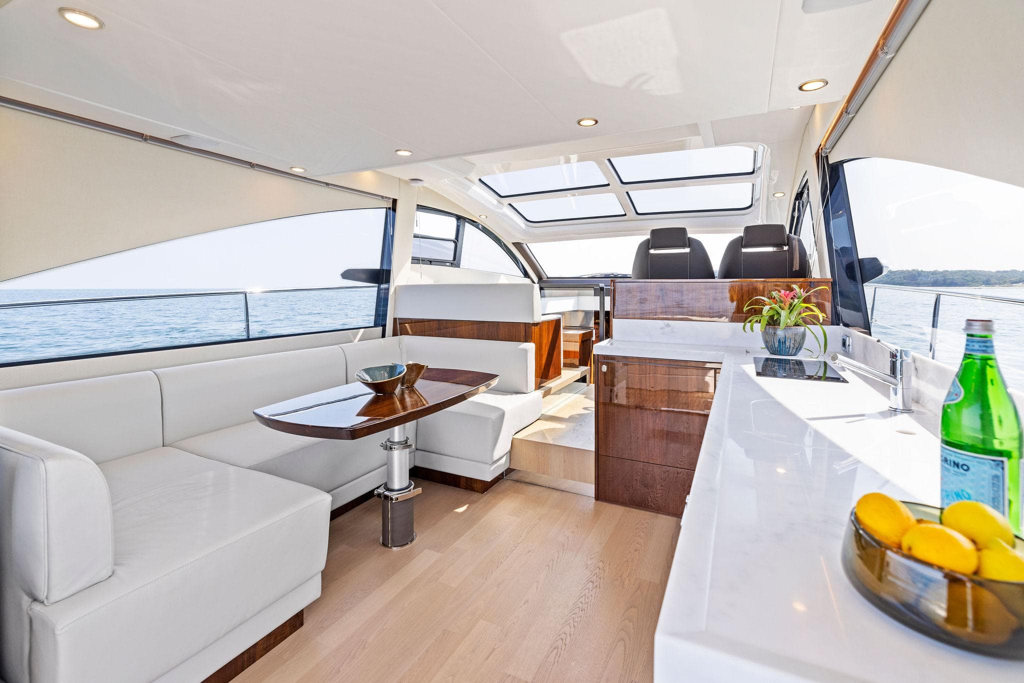 Luxurious interior of 2025 Fairline Targa 50 GT yacht with modern seating and panoramic windows.