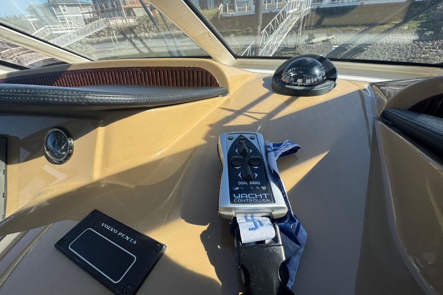 Control panel of 2004 Carver 564 Cockpit Motor Yacht with yacht controller and compass.