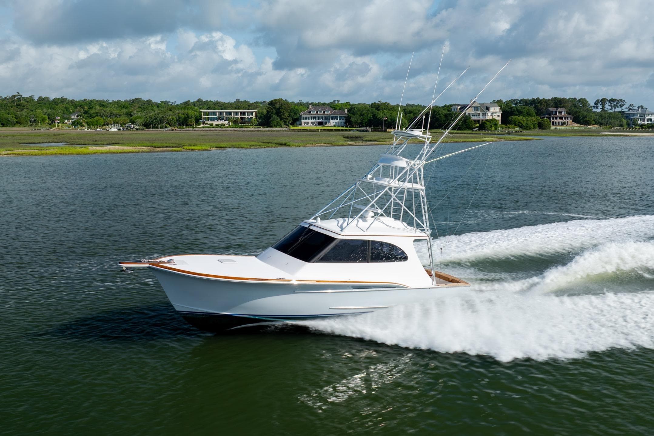 2015 Jarrett Bay Hardtop Express Sportfish cruising on a scenic waterway.