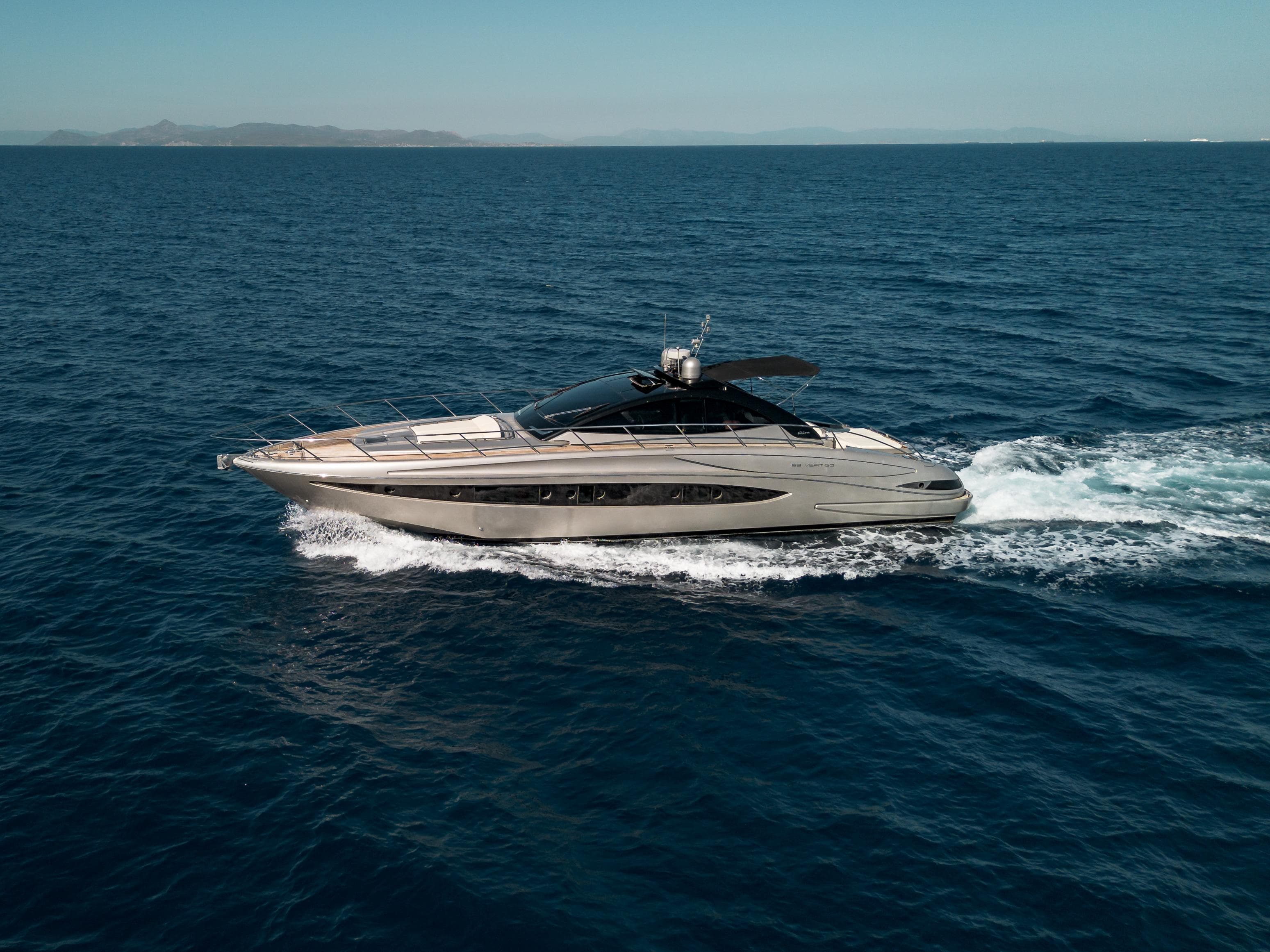 2009 Riva 63 Vertigo yacht cruising on open sea under clear skies.