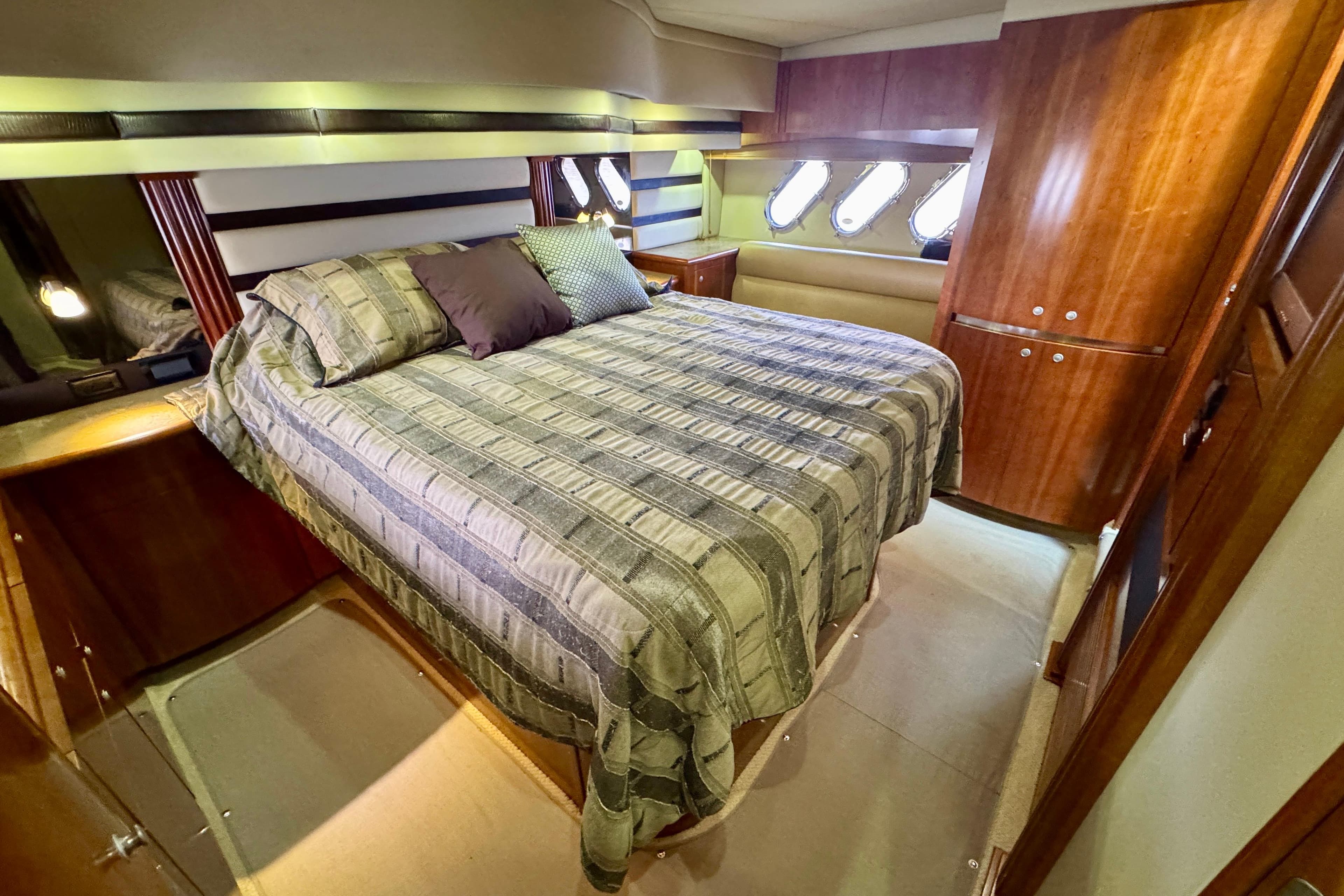 Luxurious bedroom interior of 2009 Cruisers Yachts 520 Sports Coupe with elegant wood finishes.