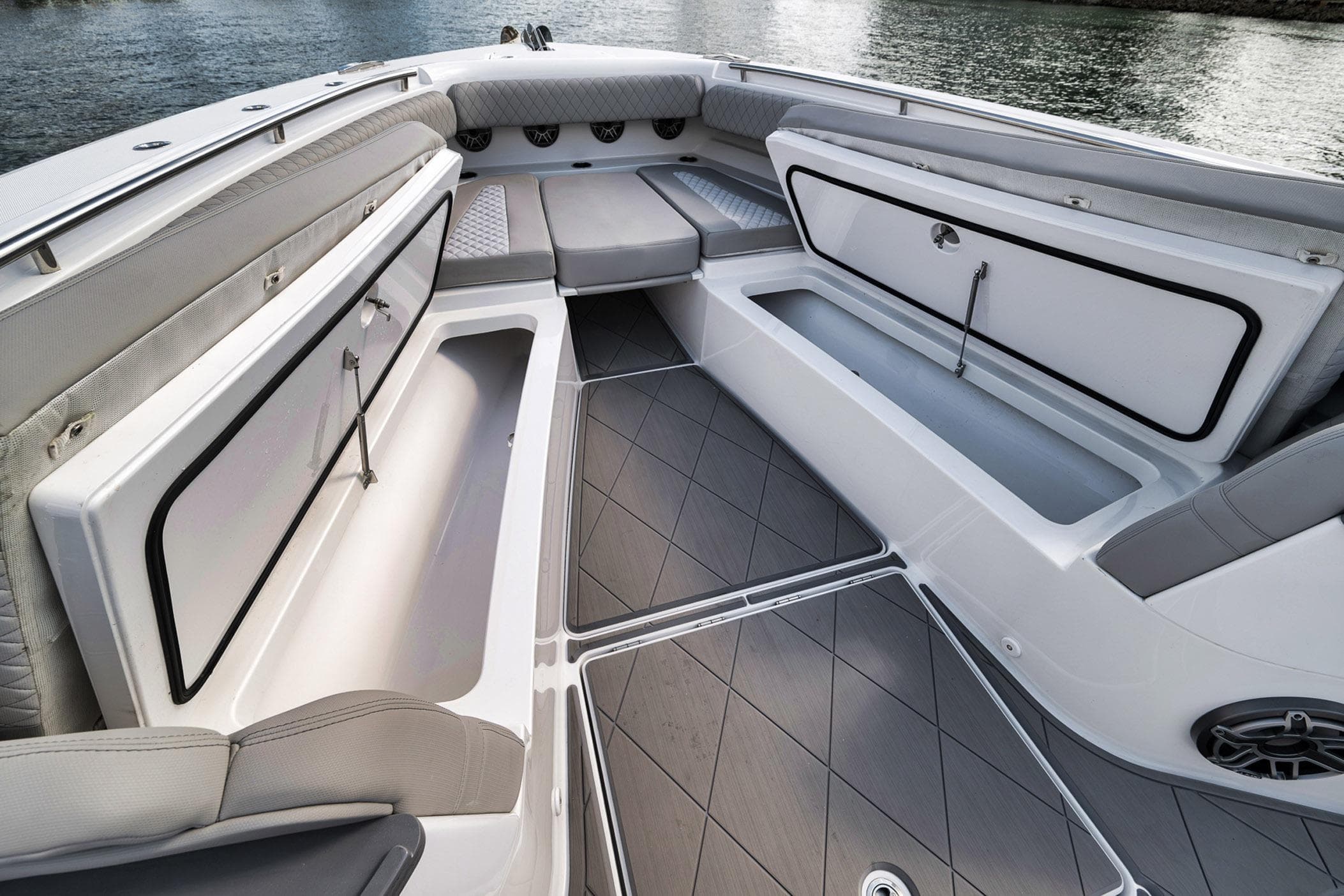 2025 HCB 53 Suenos boat interior with open storage compartments and cushioned seating.