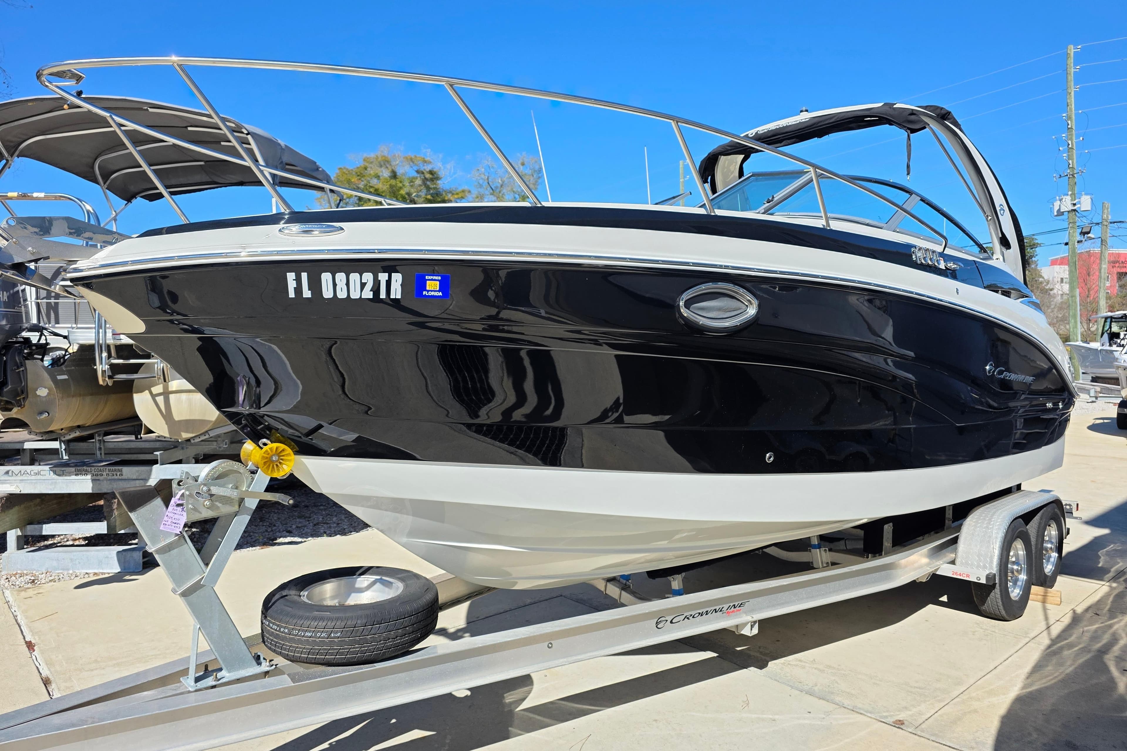 2022 Crownline 264 CR boat on trailer, black and white exterior, sunny day.