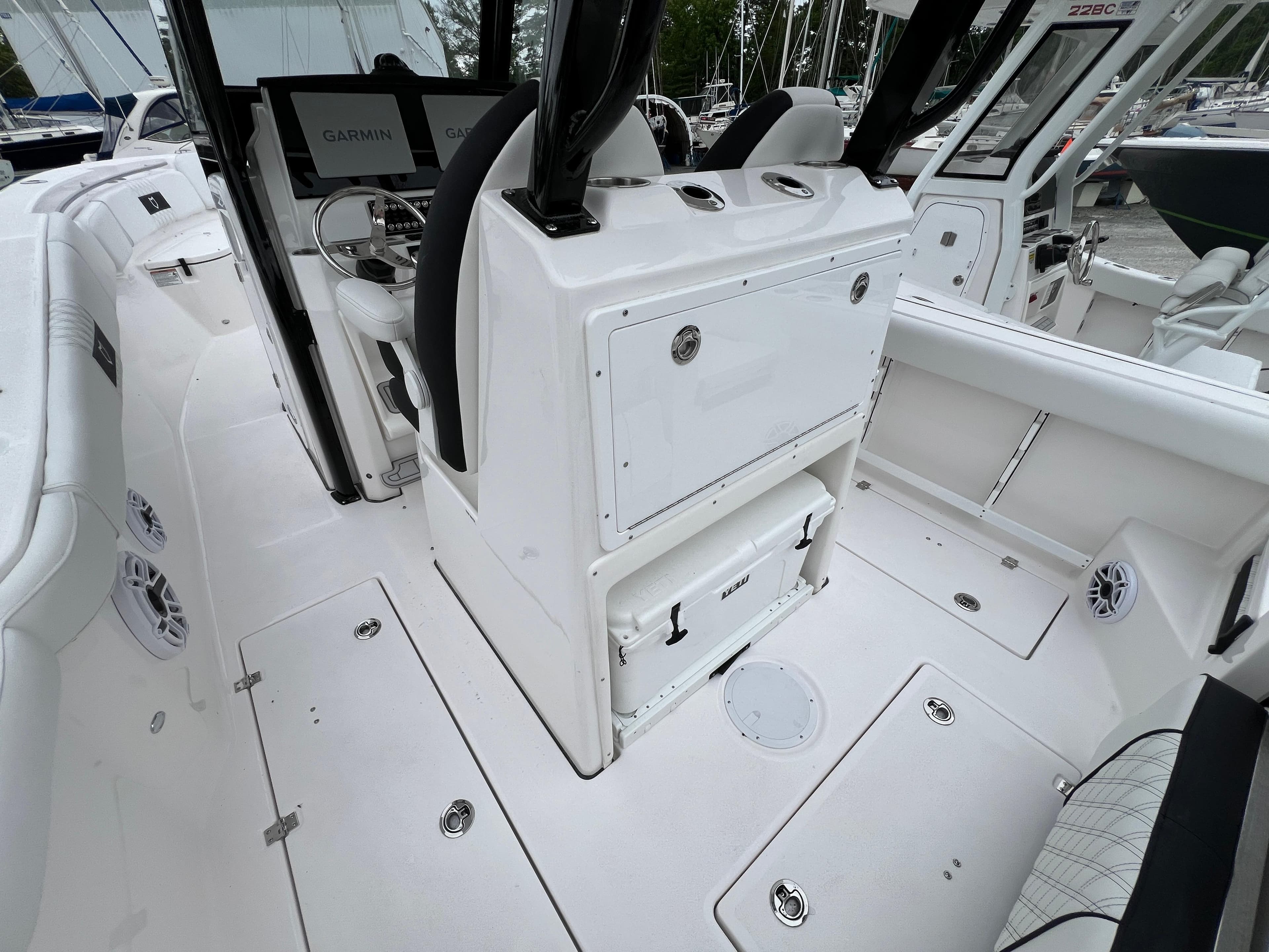 2025 Sea Fox 288 Commander boat interior with white seating and Garmin navigation system.