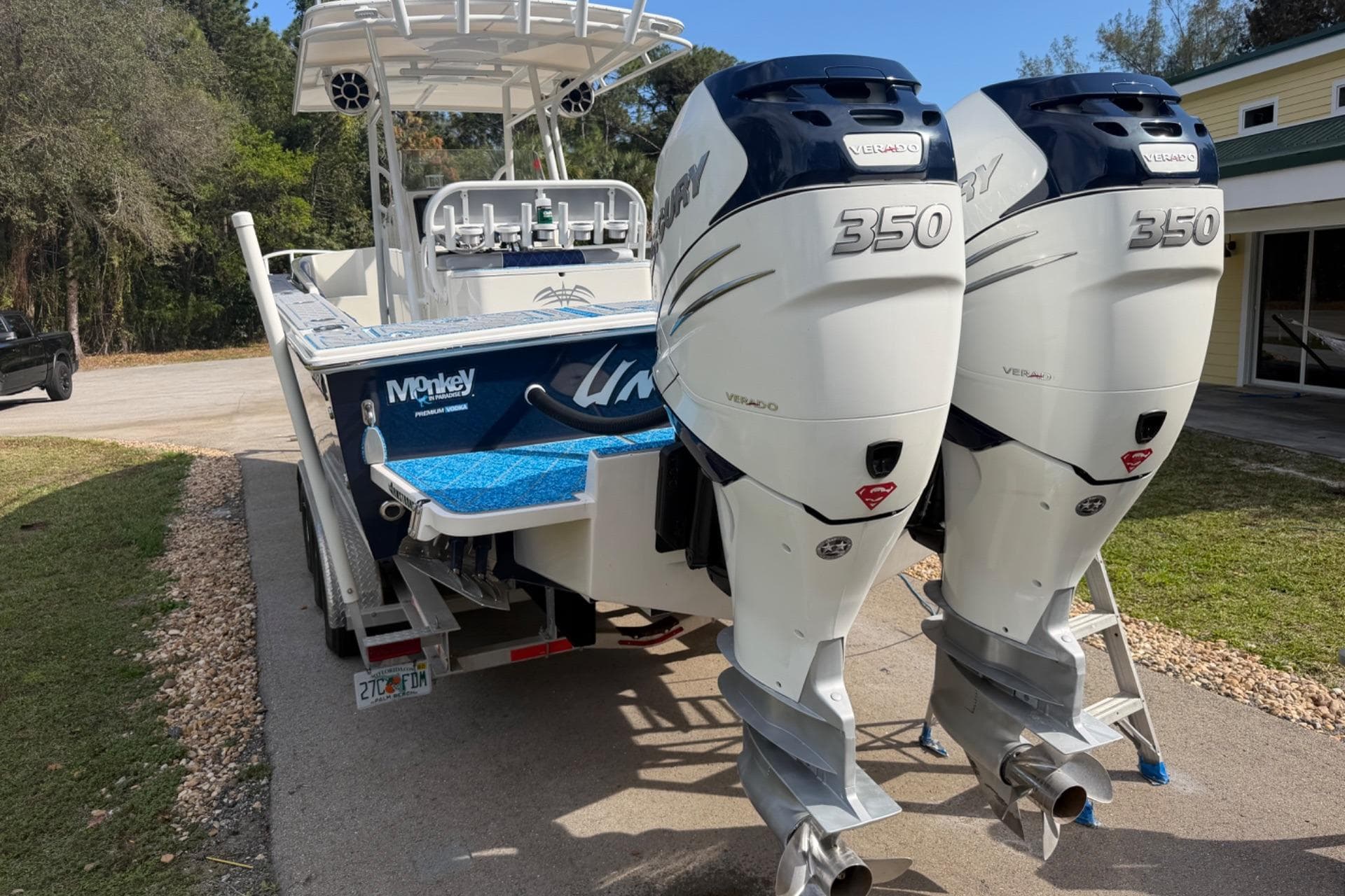 2004 Jupiter 31 Cuddy boat with twin Mercury 350 Verado engines on a trailer.