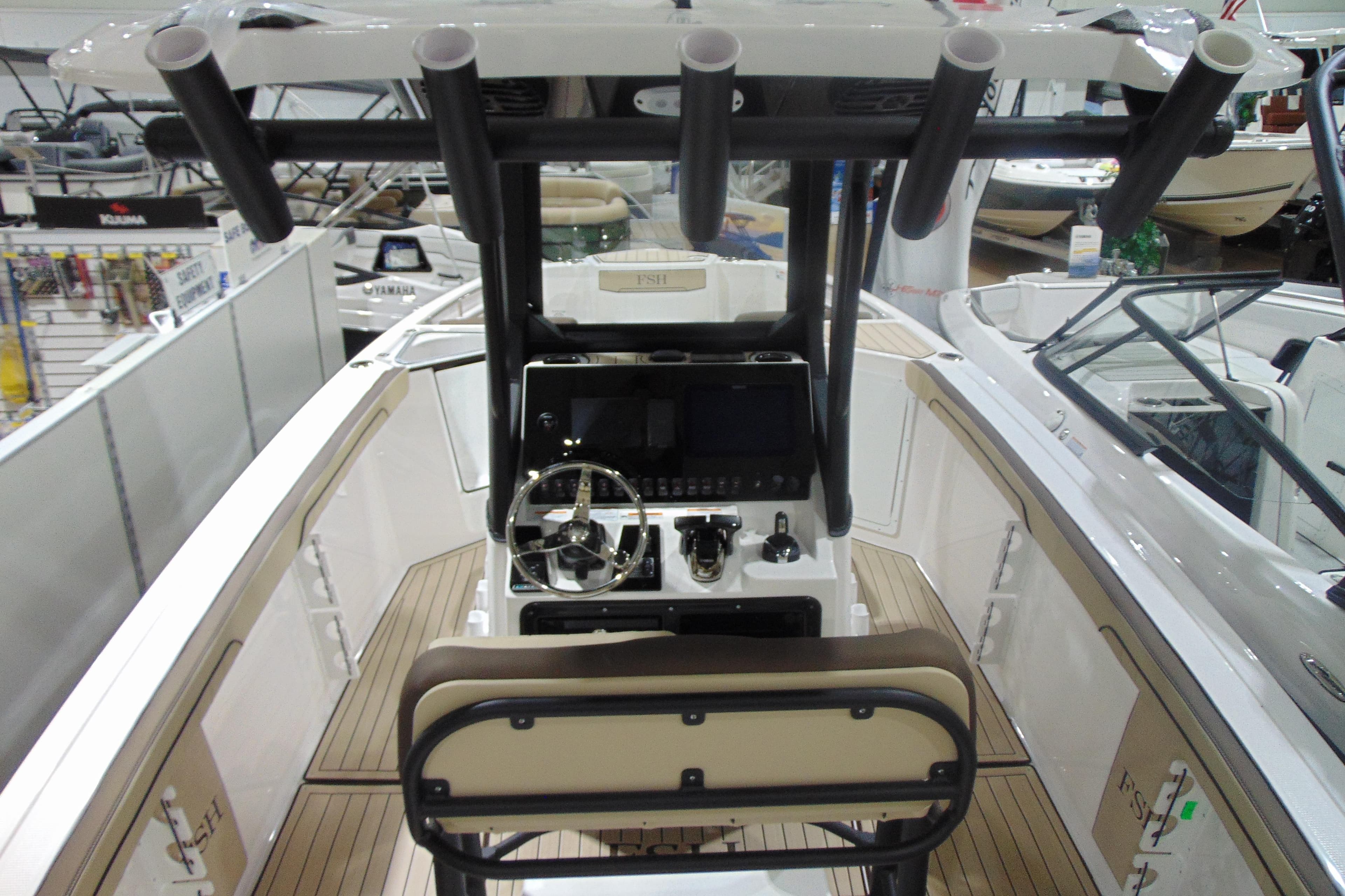 2026 Yamaha Boats 255 FSH Sport H interior with steering console and rod holders.