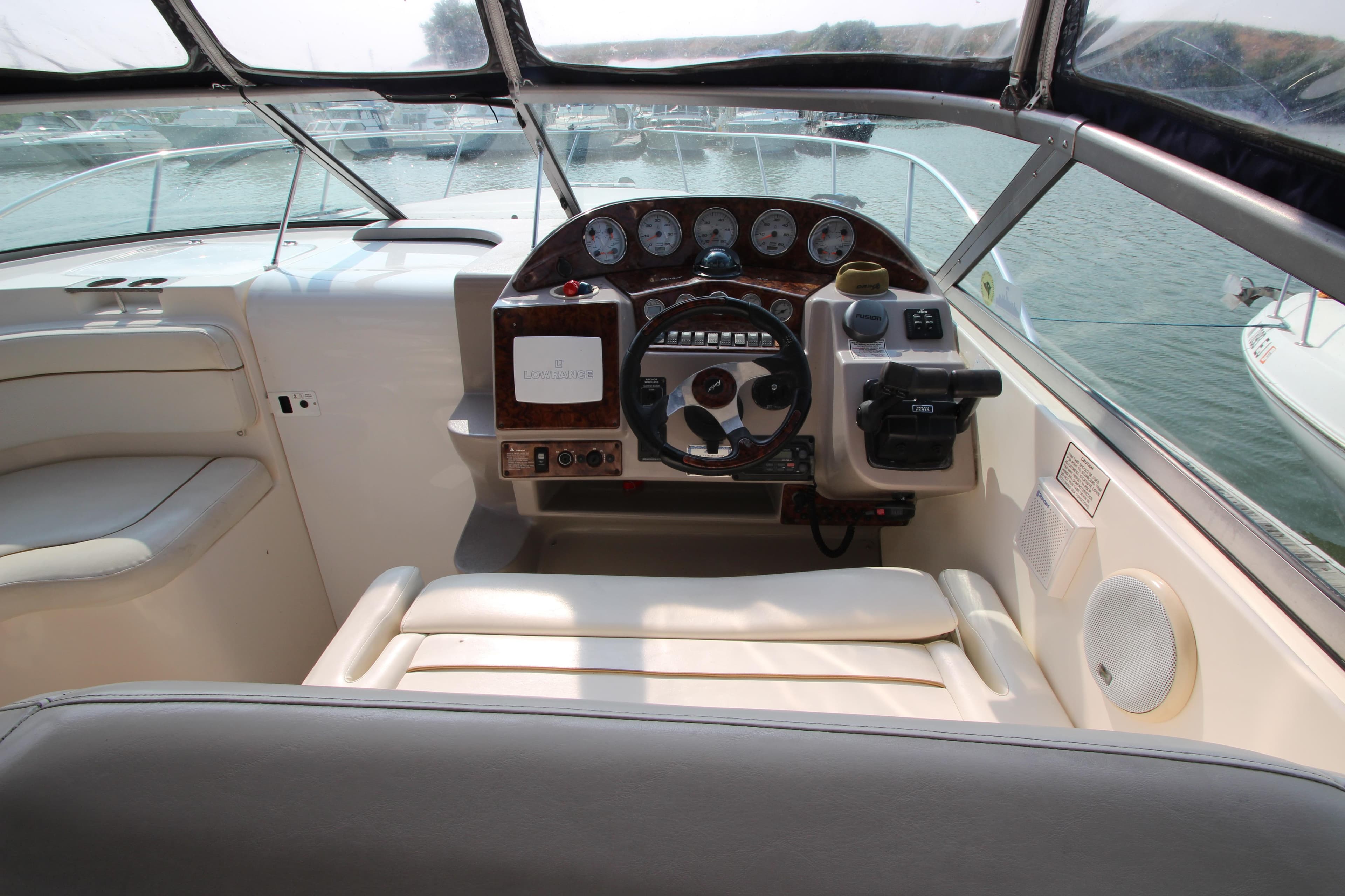 2005 Rinker 312 Fiesta Vee boat cockpit with steering wheel and control panel.