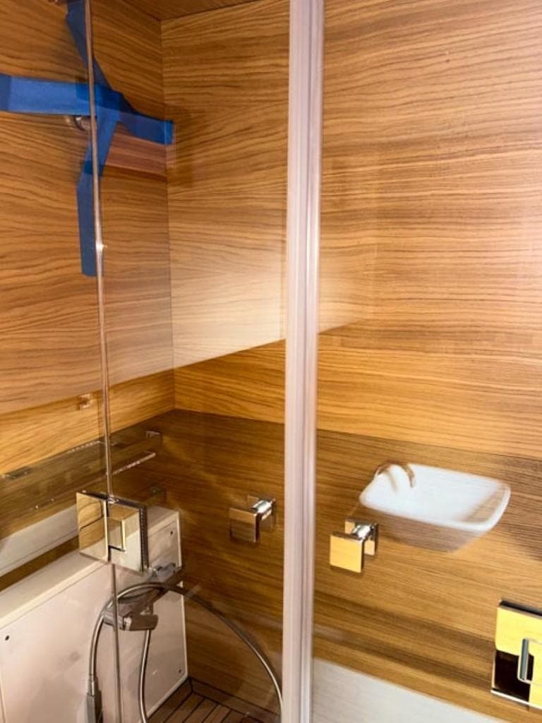 2023 De Antonio Yachts D42 Open bathroom with modern wood paneling and sleek fixtures.