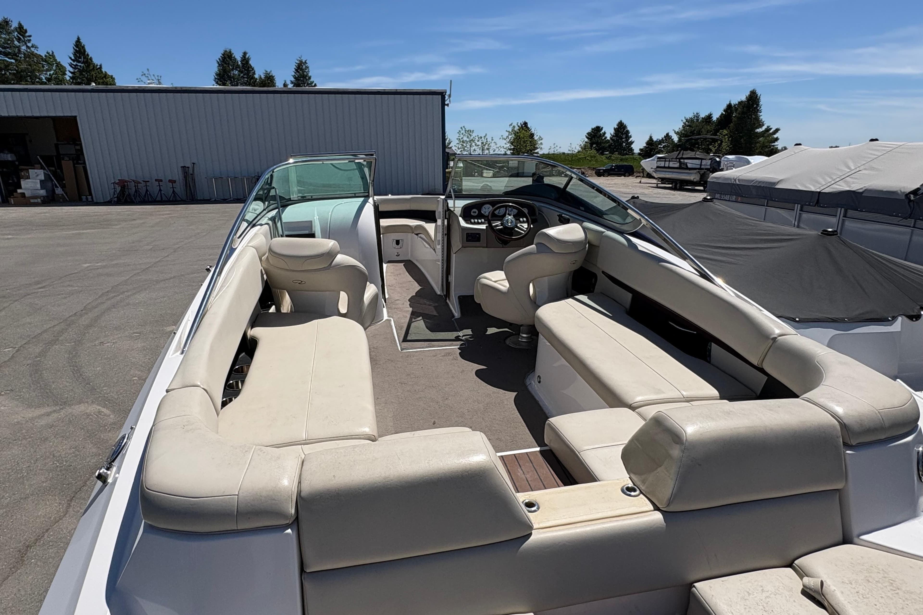 2009 Regal 2500 Bowrider boat with spacious seating, parked outdoors under clear skies.