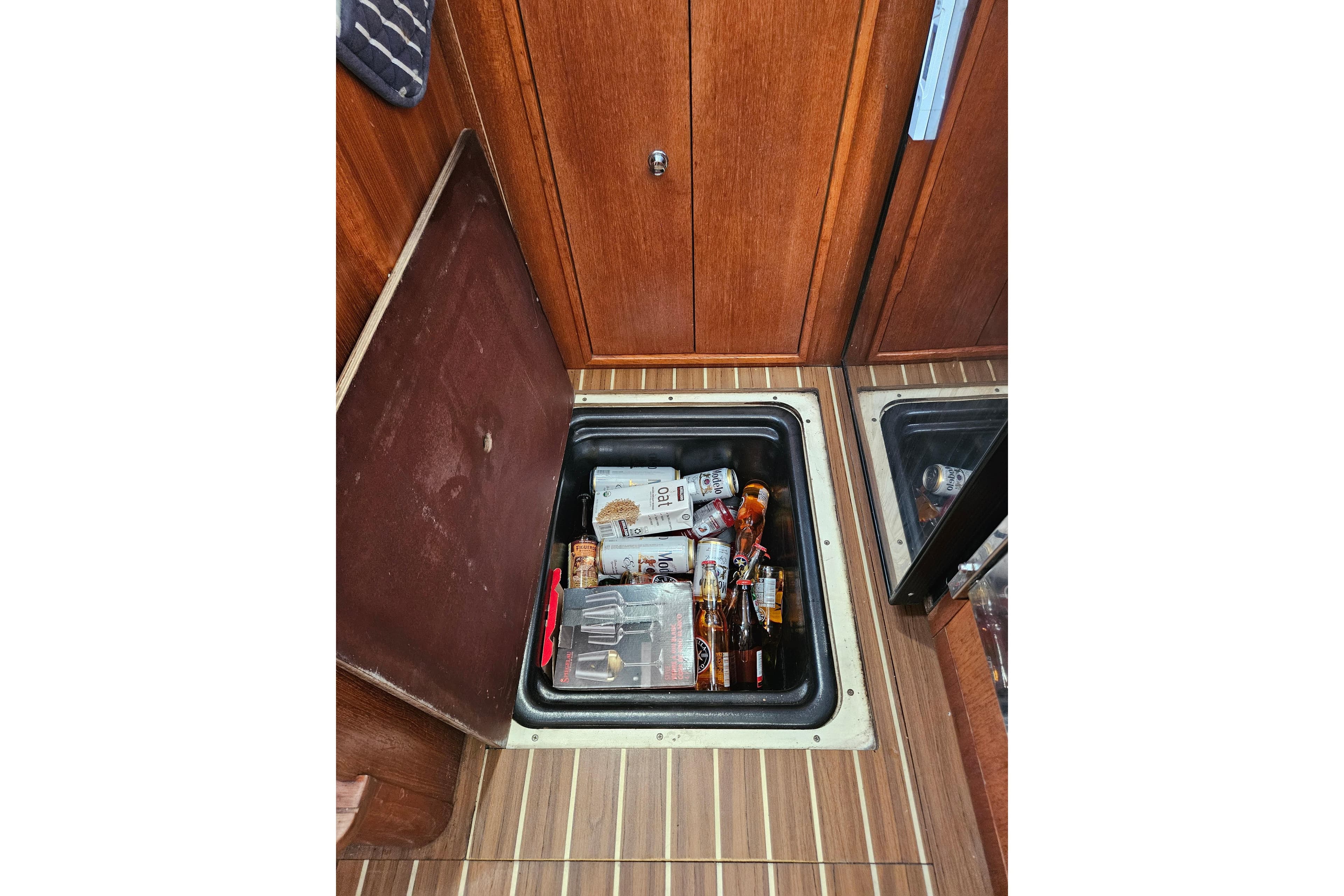 Storage compartment in 2005 Hunter 41 AC yacht with beverages and supplies.