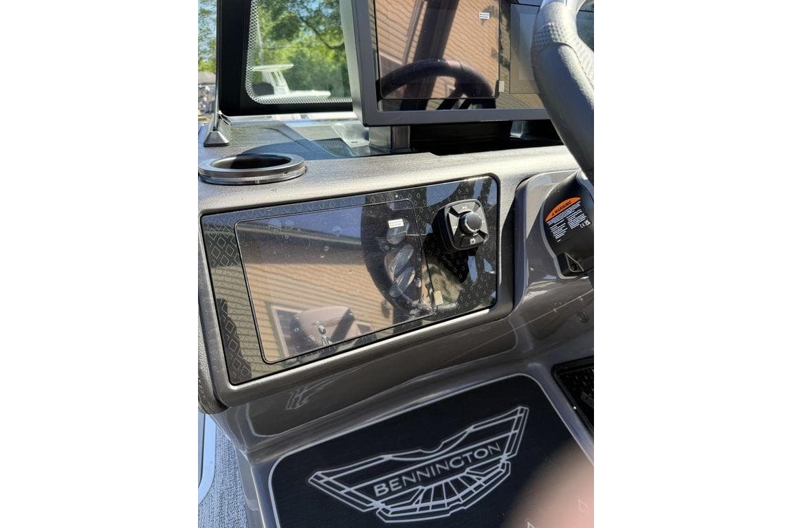 2026 Bennington M Swingback 24 MSB dashboard with steering wheel and control panel.