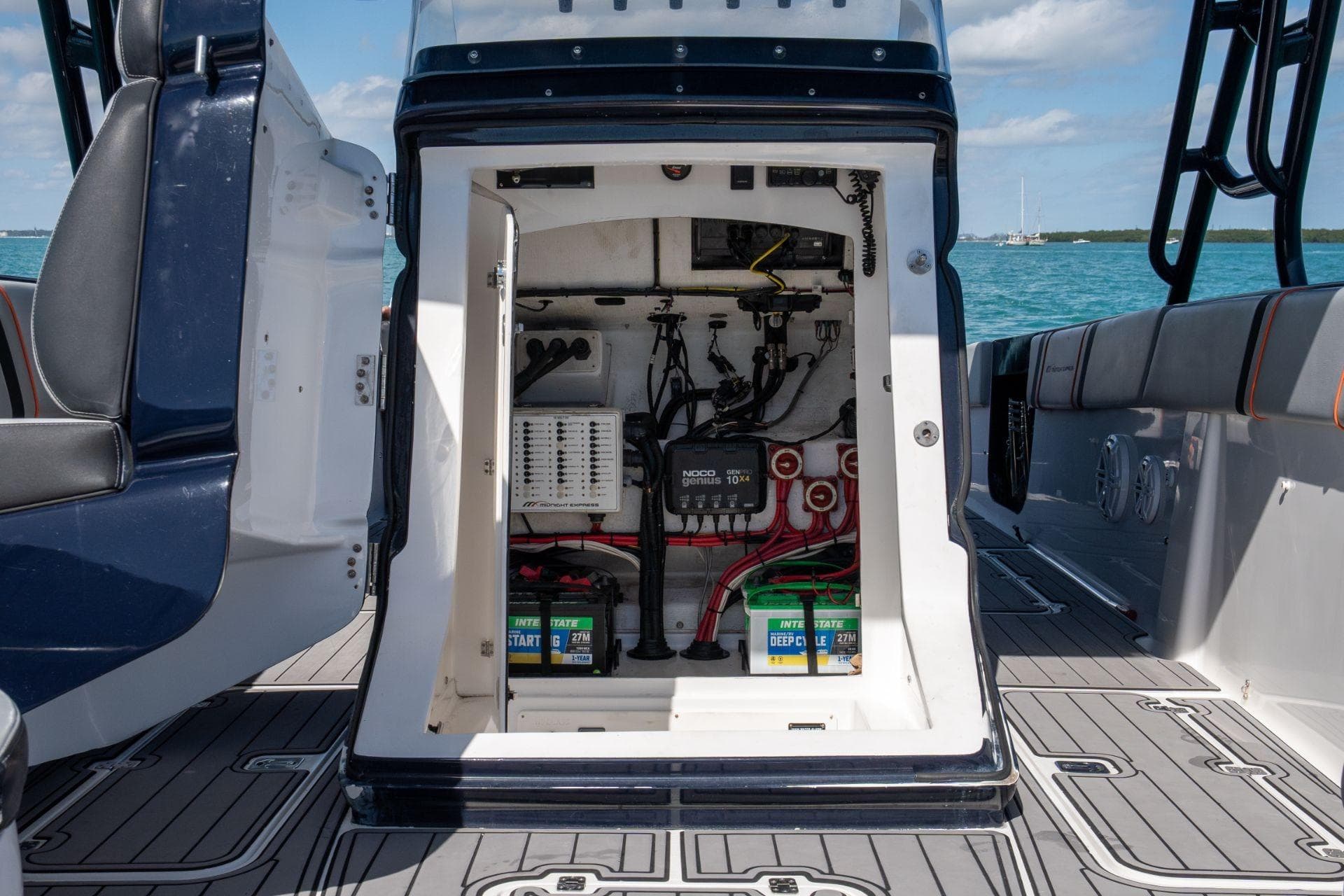 Electrical compartment of a 2014 Midnight Express 37 Open boat, featuring batteries and wiring.