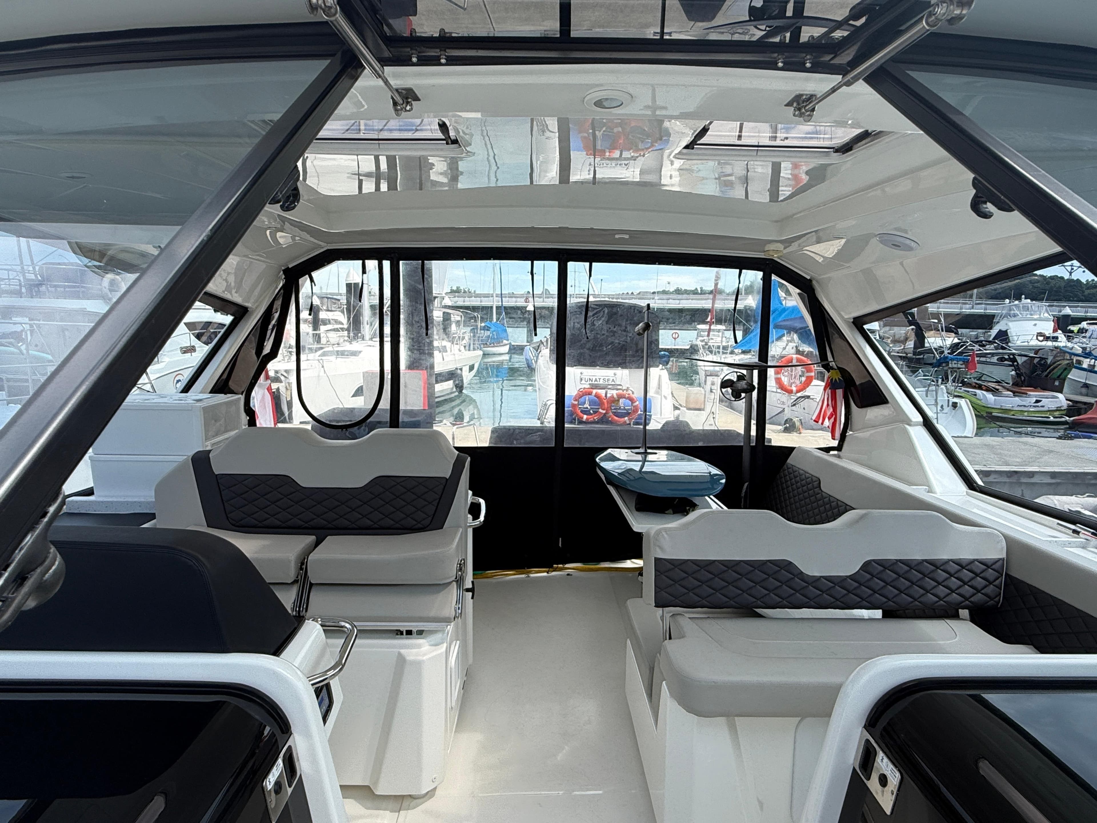 Interior of 2022 Aquila 36 Sport yacht with modern seating and panoramic windows.