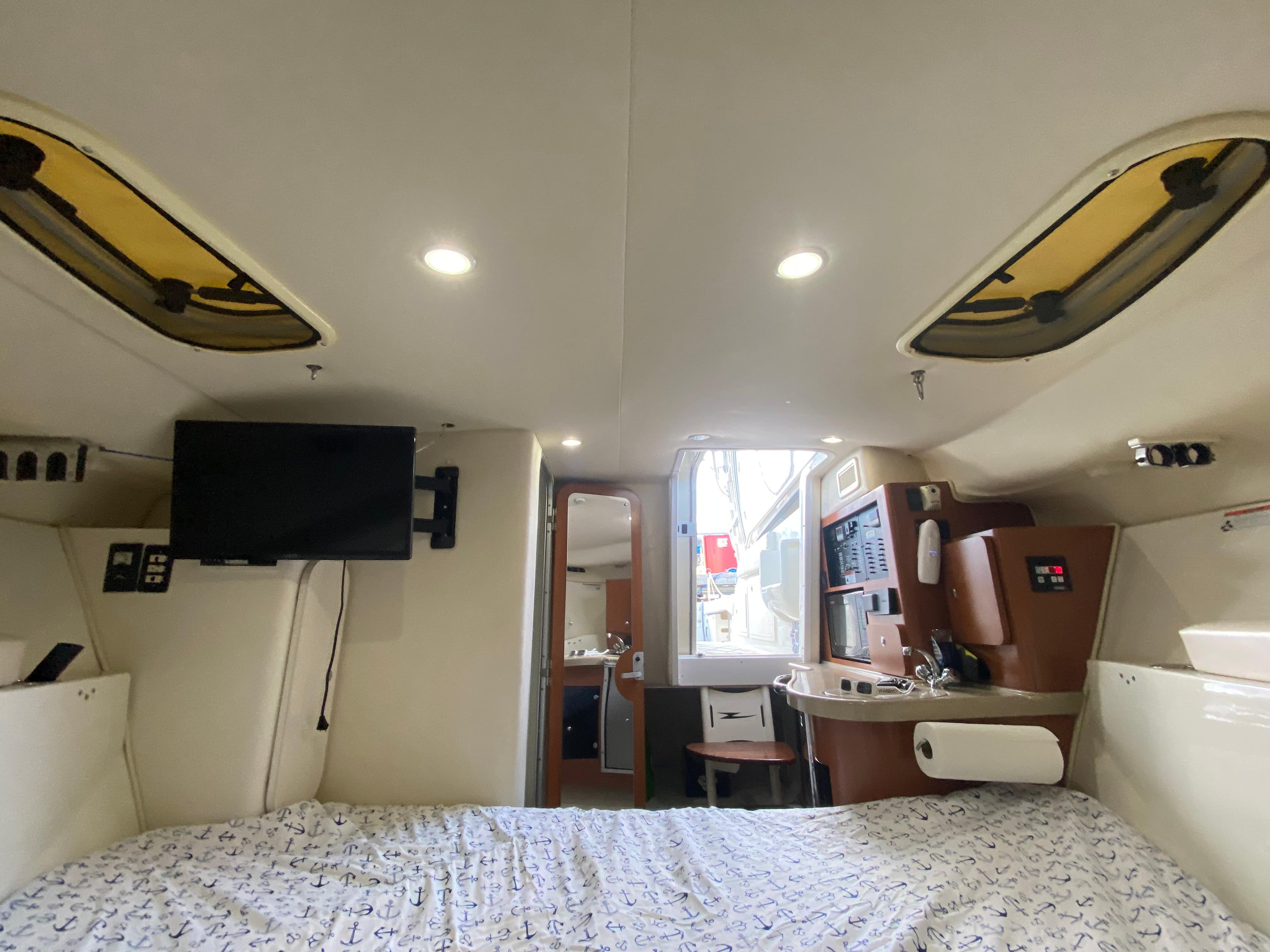 Interior of 2006 Hydra-Sports Vector 3300 VX boat with bed, TV, and kitchenette.