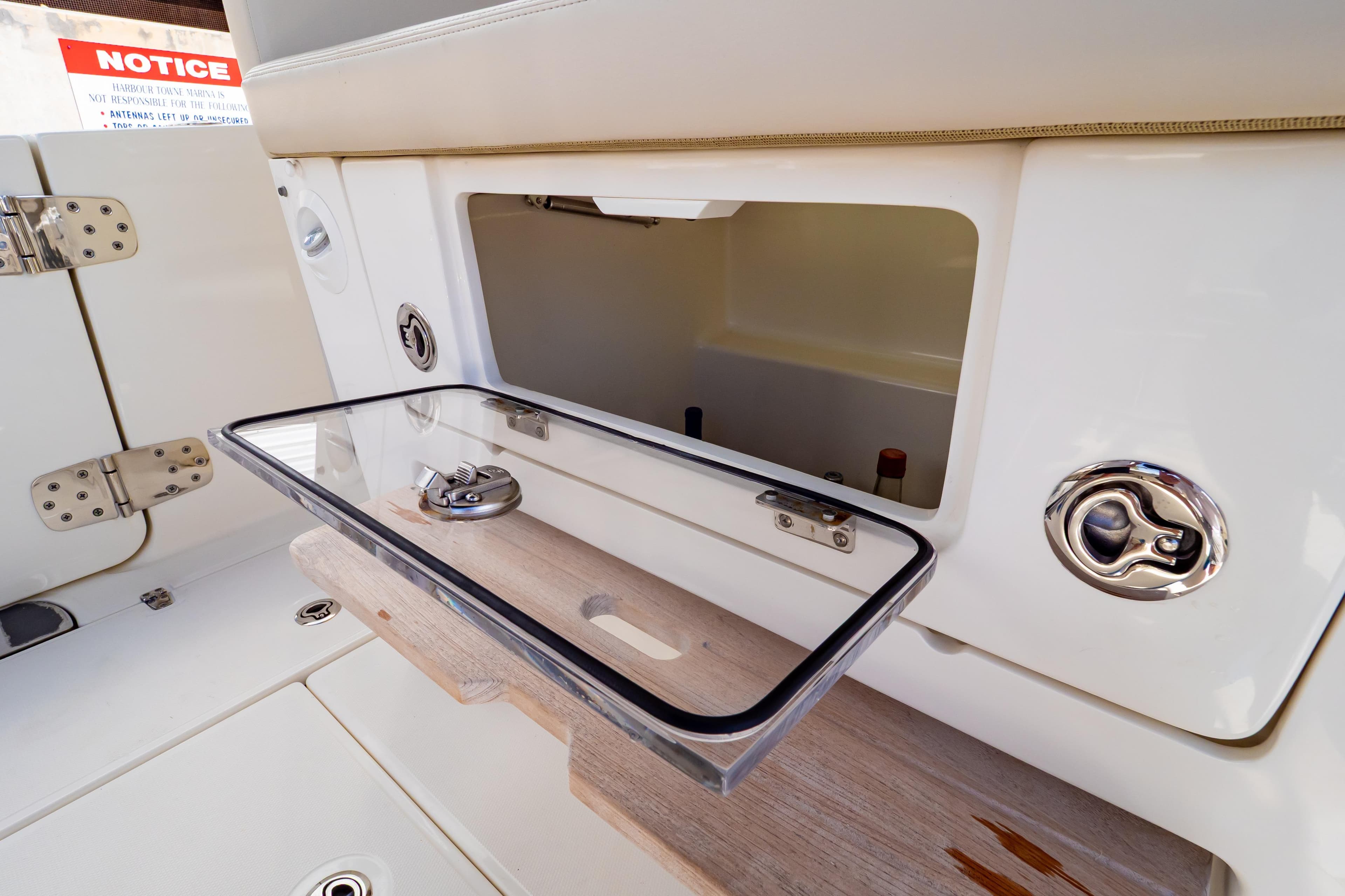 Open storage compartment on 2019 Boston Whaler 350 Realm boat, showcasing sleek design.