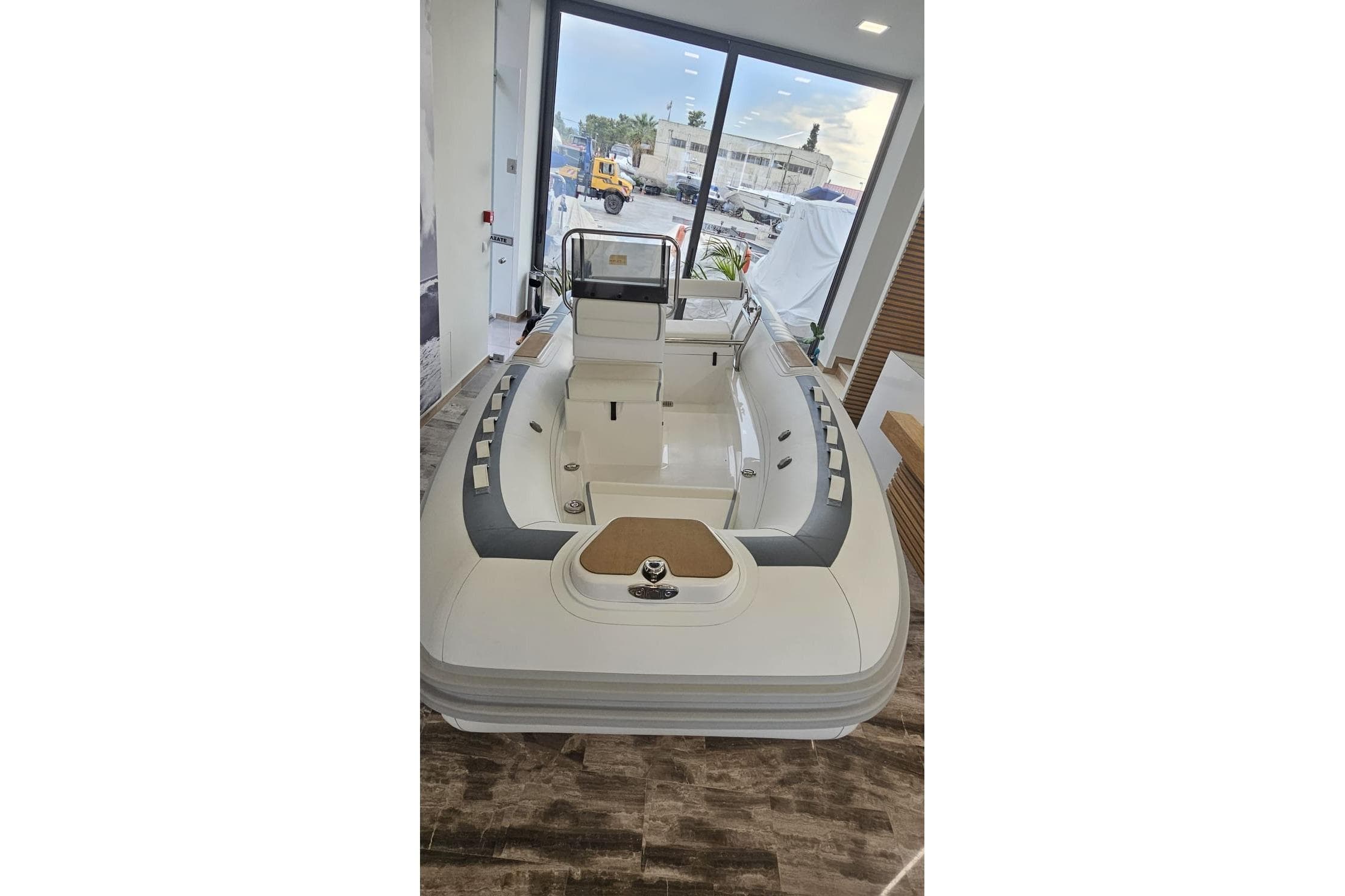 2025 Novurania DL 460 boat displayed indoors, featuring sleek design and modern seating.