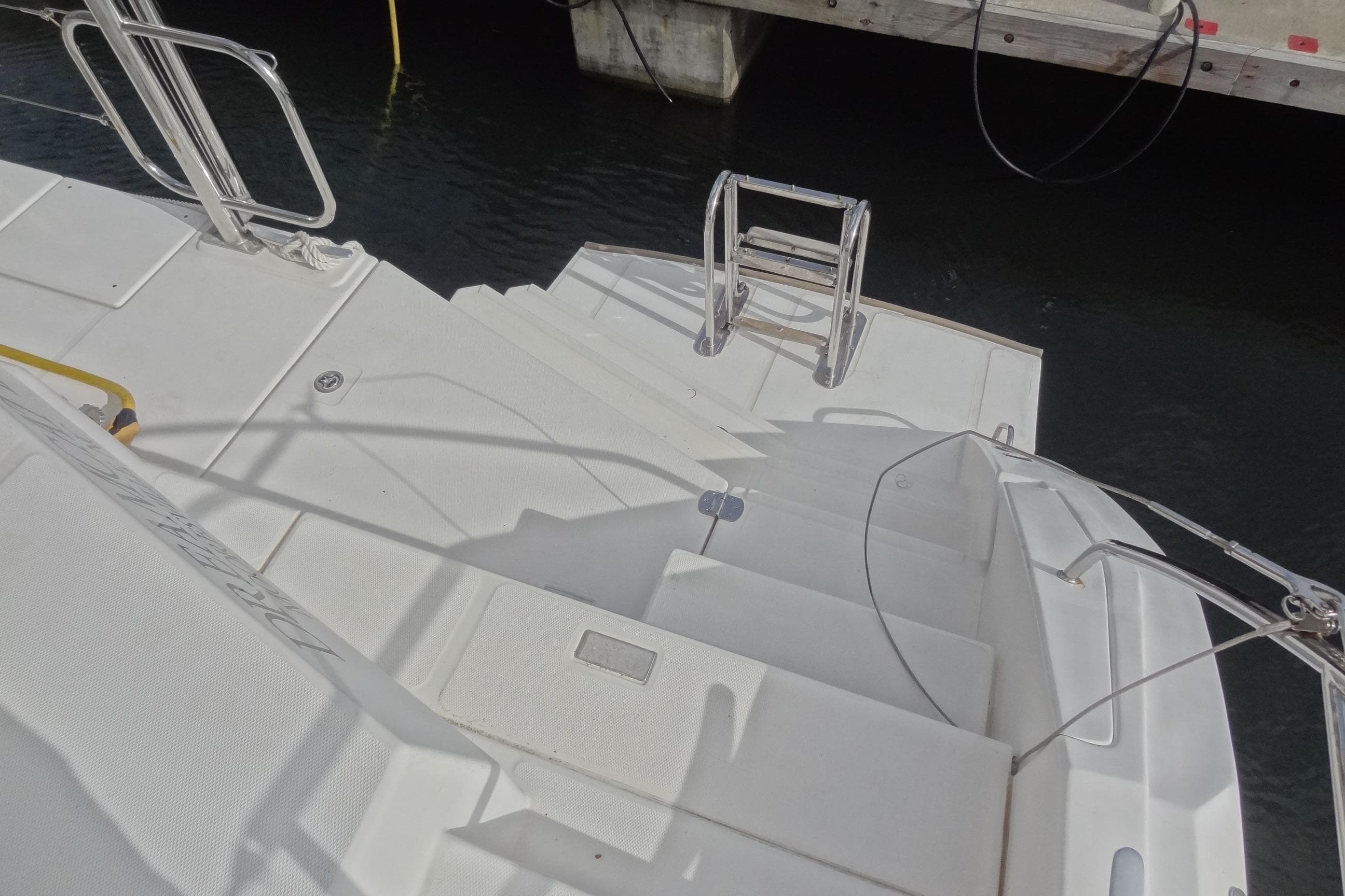 Steps leading to water on a 2021 Leopard 50 yacht, docked at a marina.