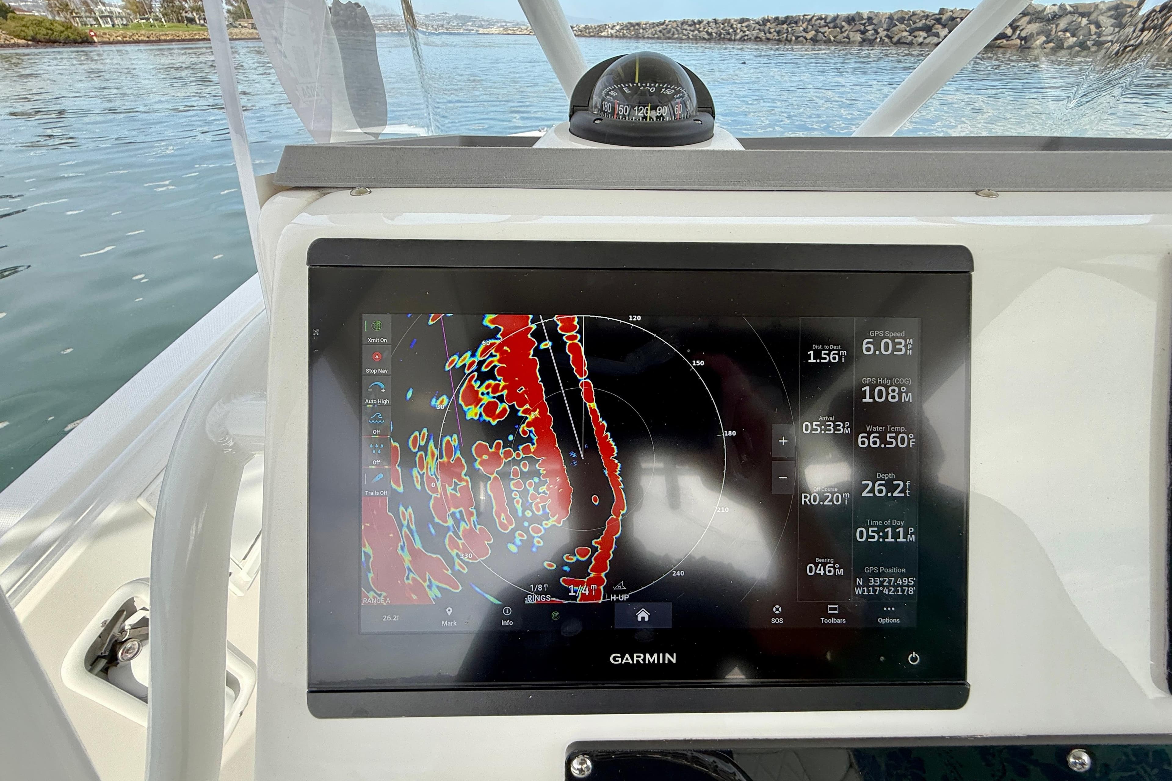 Garmin navigation display on 2023 Edgewater 245CC boat, showing radar and GPS data.
