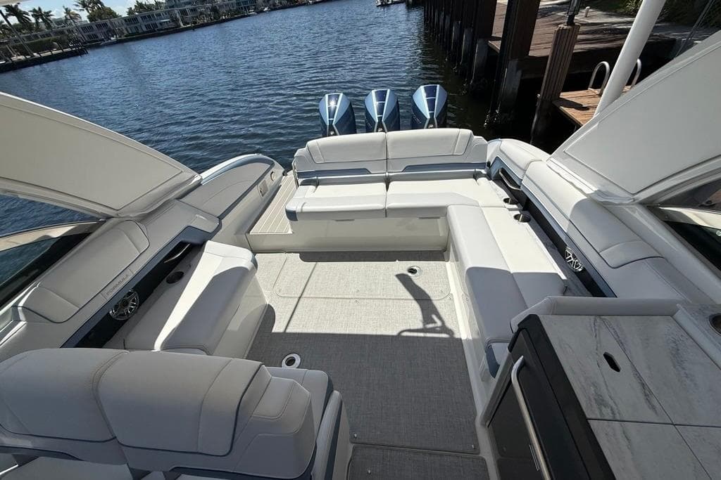2025 Formula 330 Crossover Bowrider OB with spacious seating and triple outboard engines.