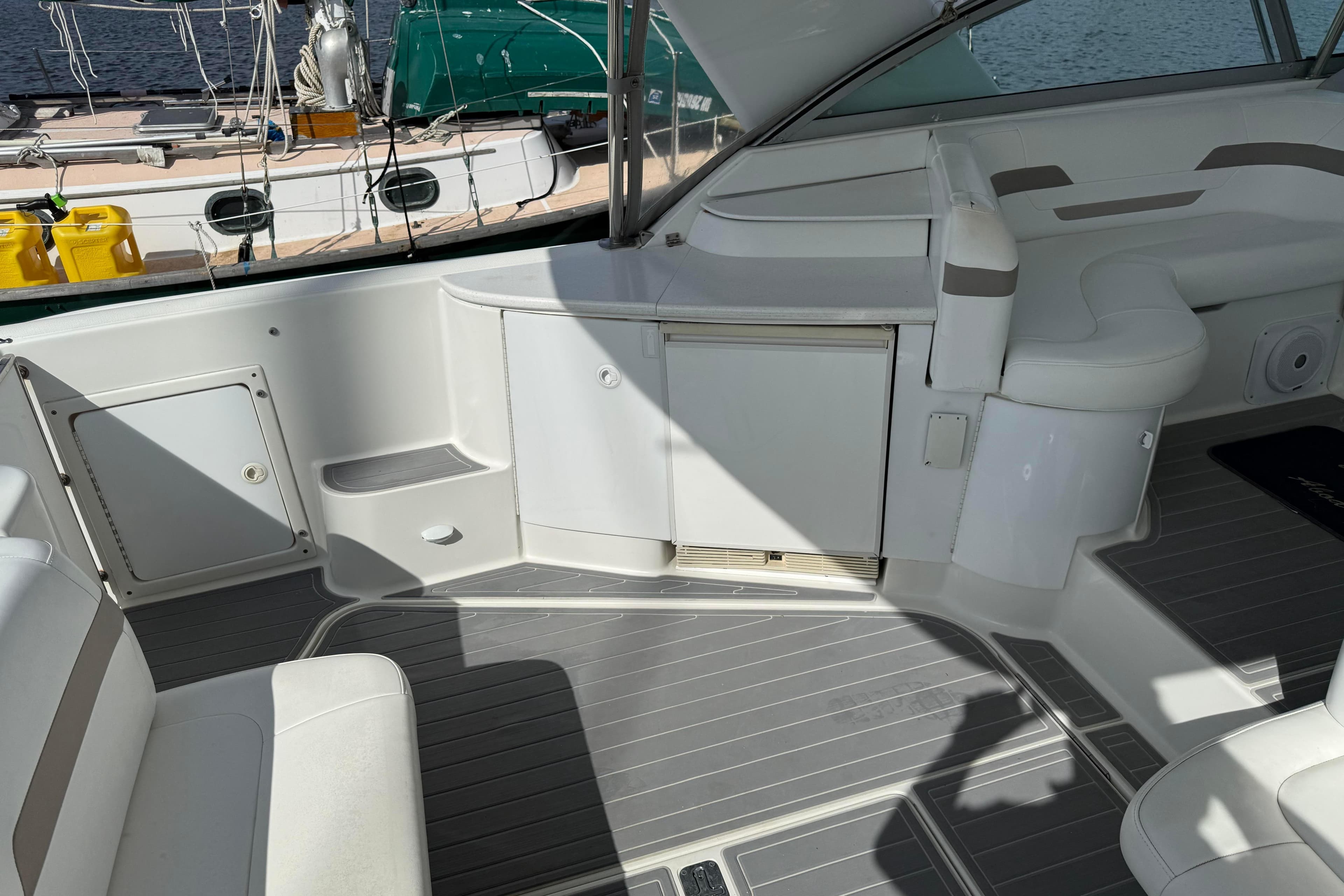 Interior of a 2000 Formula 41 Performance Cruiser boat, featuring white seating and storage.