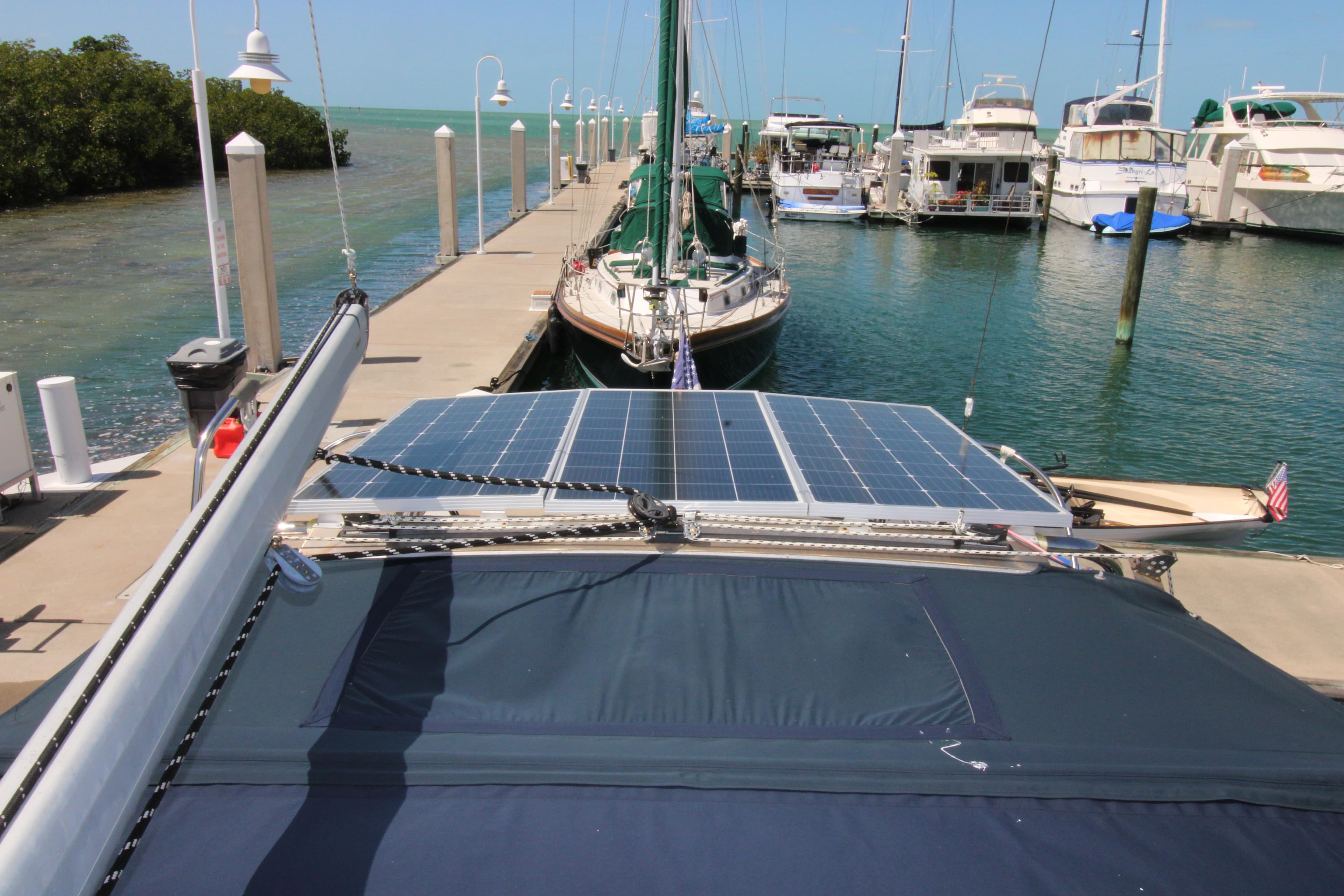 Sailboat with solar panels docked at marina, Hunter 410 model, 2002.