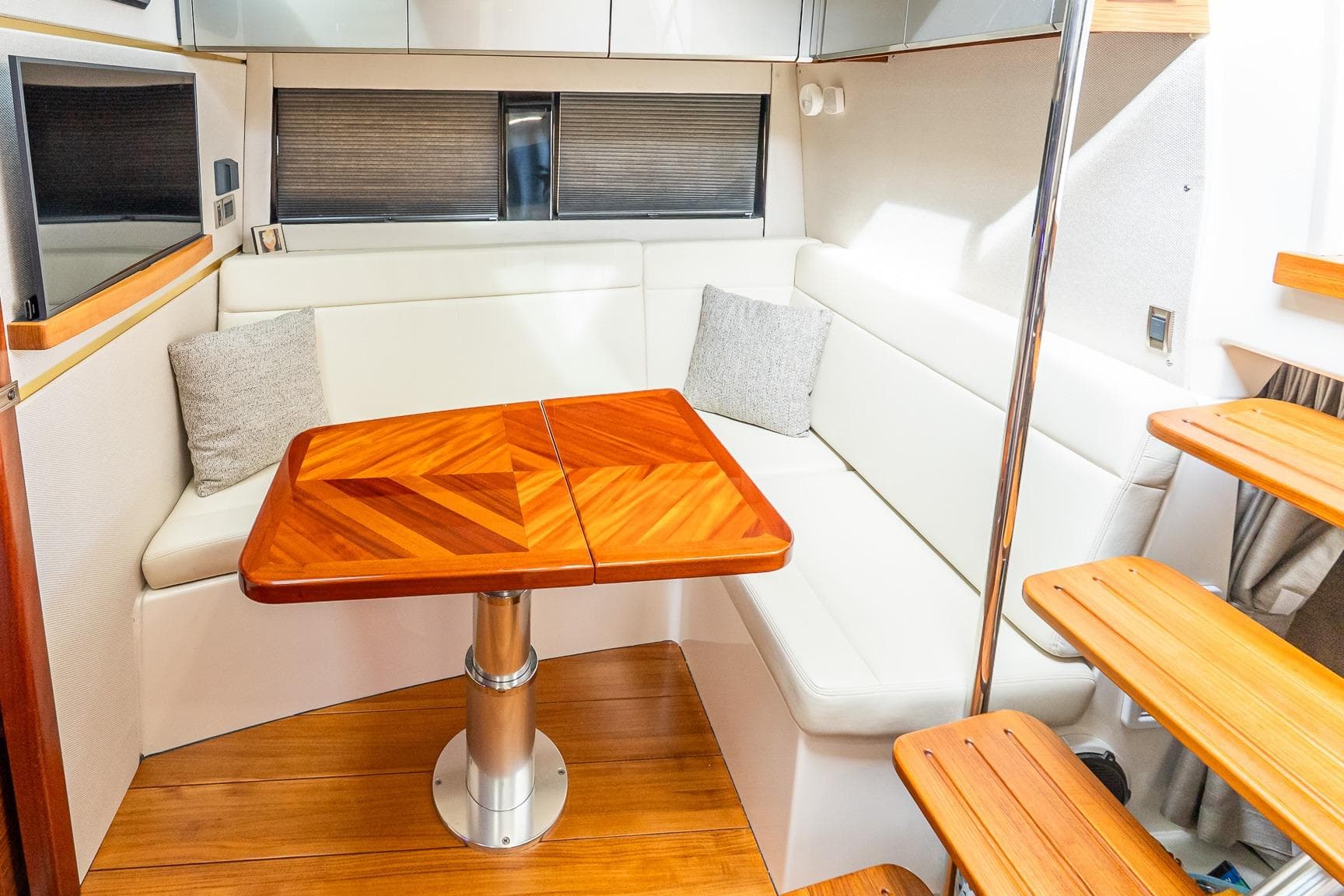 2024 Boston Whaler 405 Conquest interior with elegant wood table and white seating.