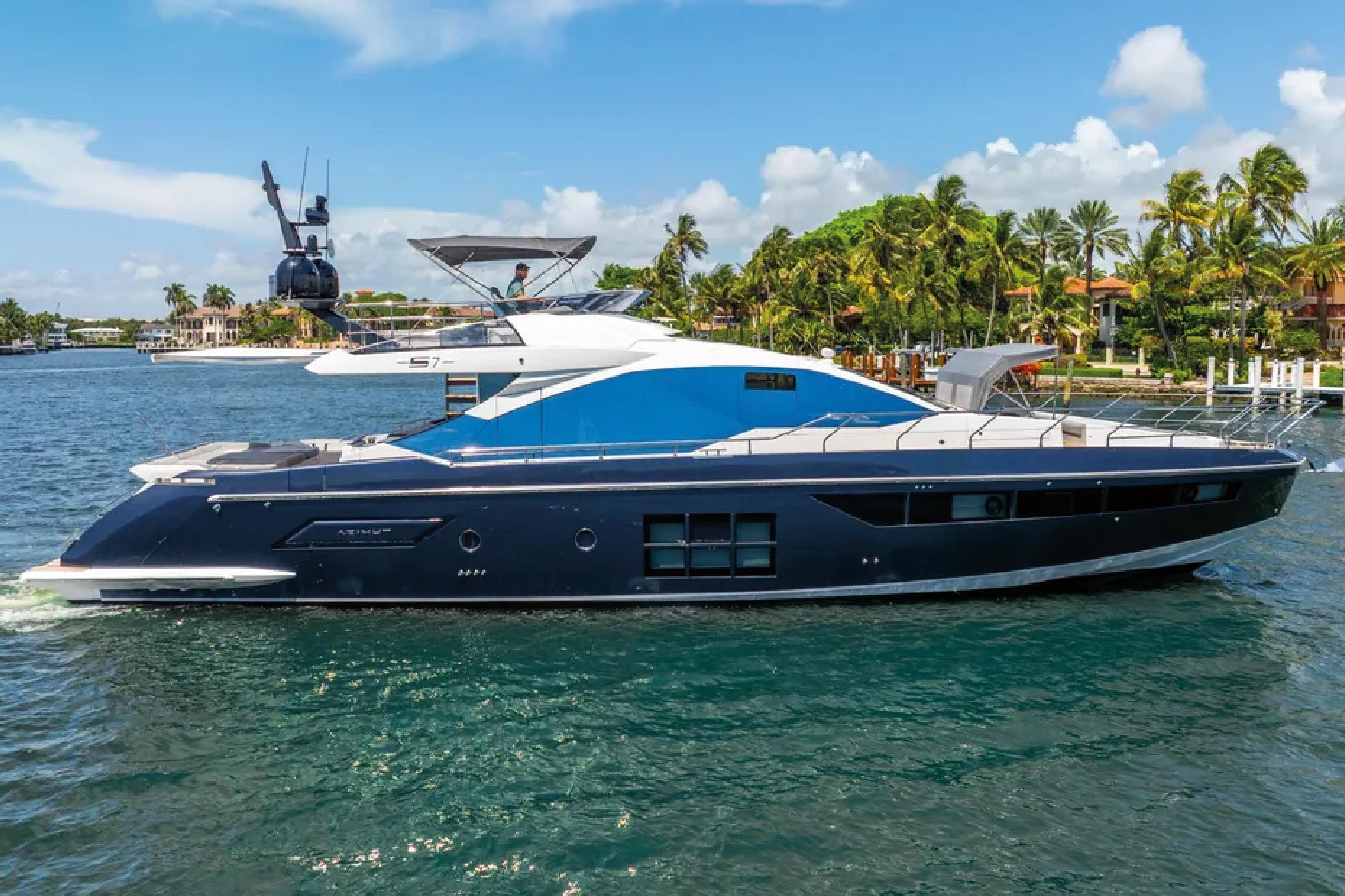 2019 Azimut S7 yacht cruising on a sunny day near palm-lined shore.