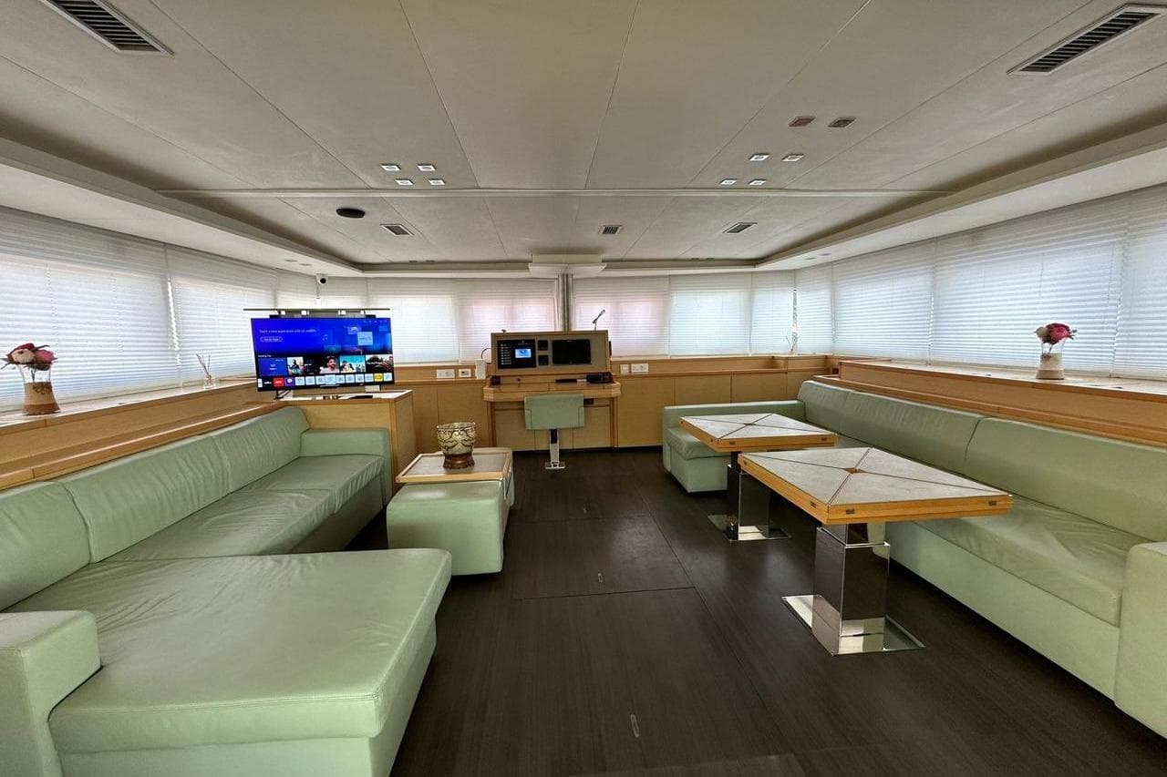 Luxurious interior of 2013 Lagoon 620 yacht with modern seating and entertainment system.
