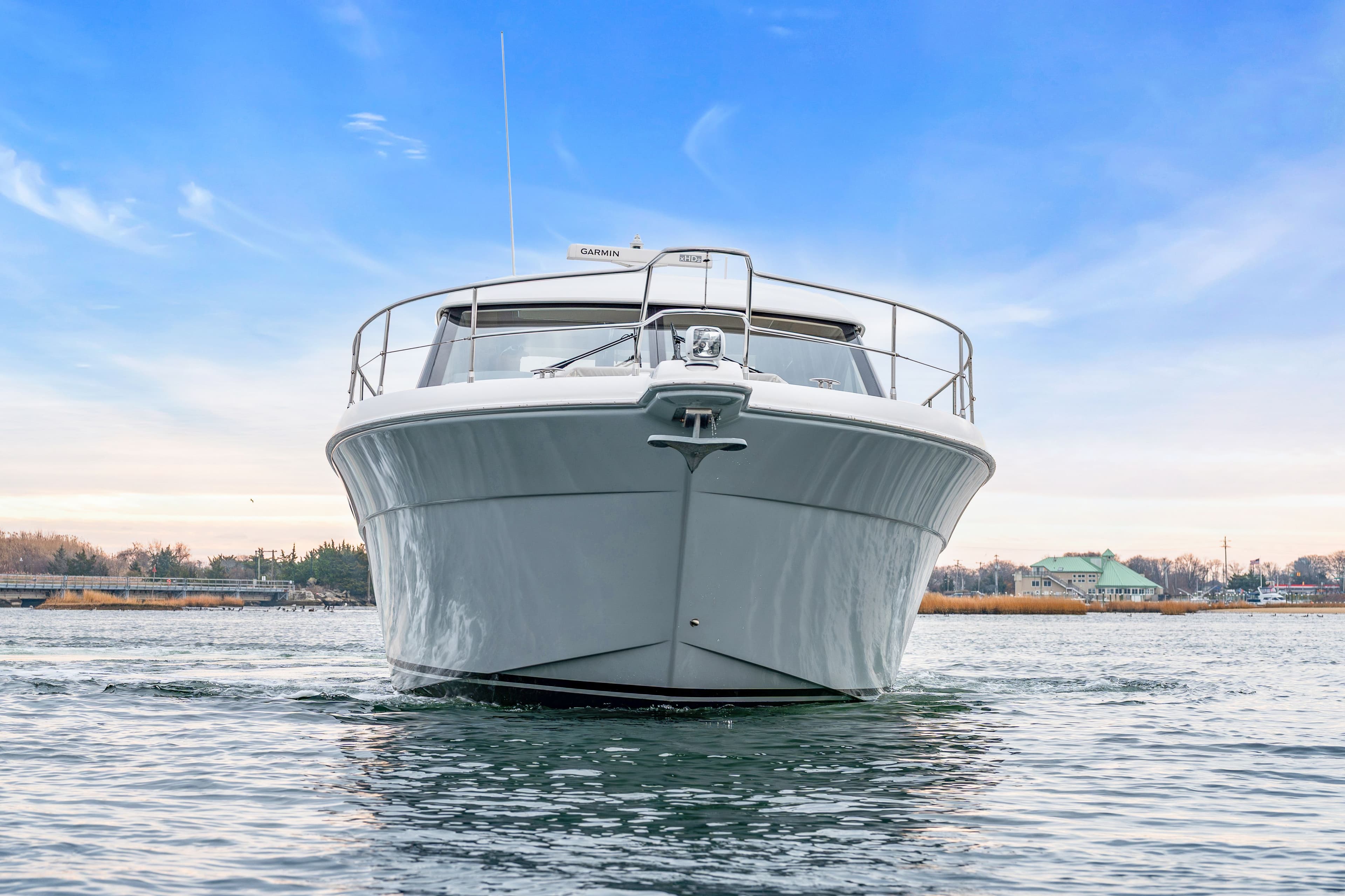 Riviera 44 Sport Yacht 2014 on calm water under blue sky.