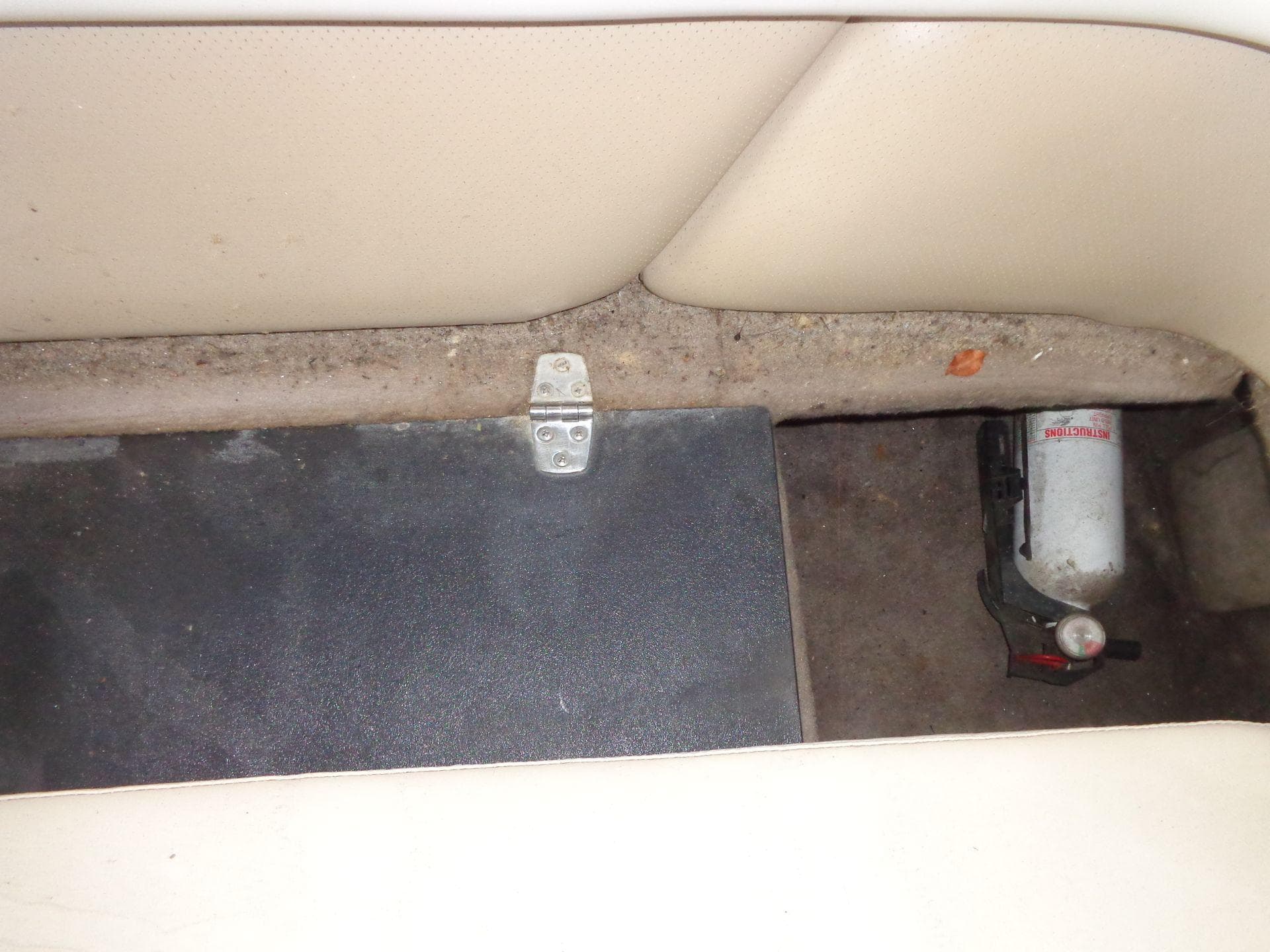 Interior of 1998 Malibu Sunsetter VLX boat with fire extinguisher and storage compartment.