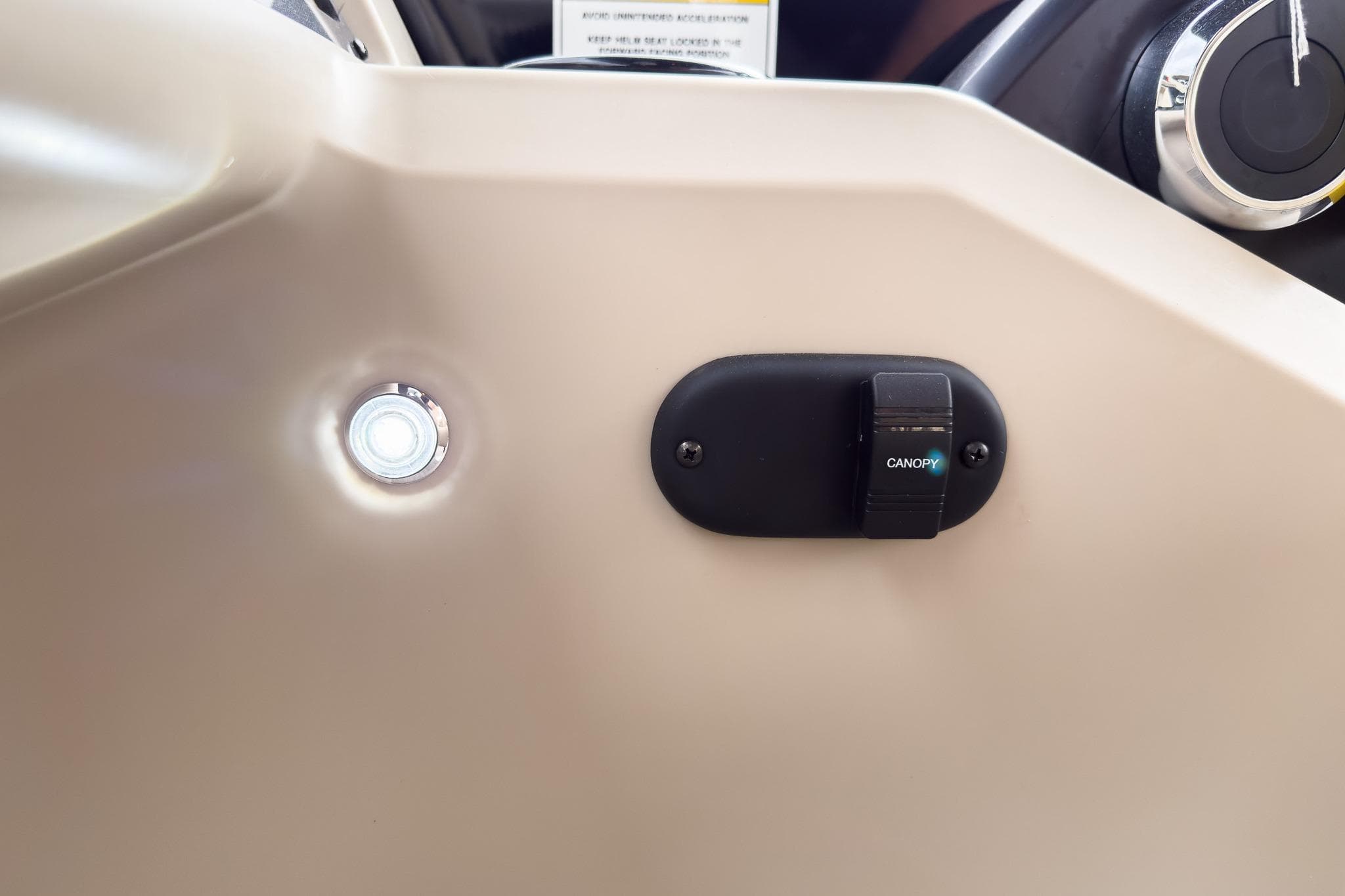 Control panel of 2026 Godfrey Sweetwater Xperience 22' Tritoon, featuring canopy switch and light.