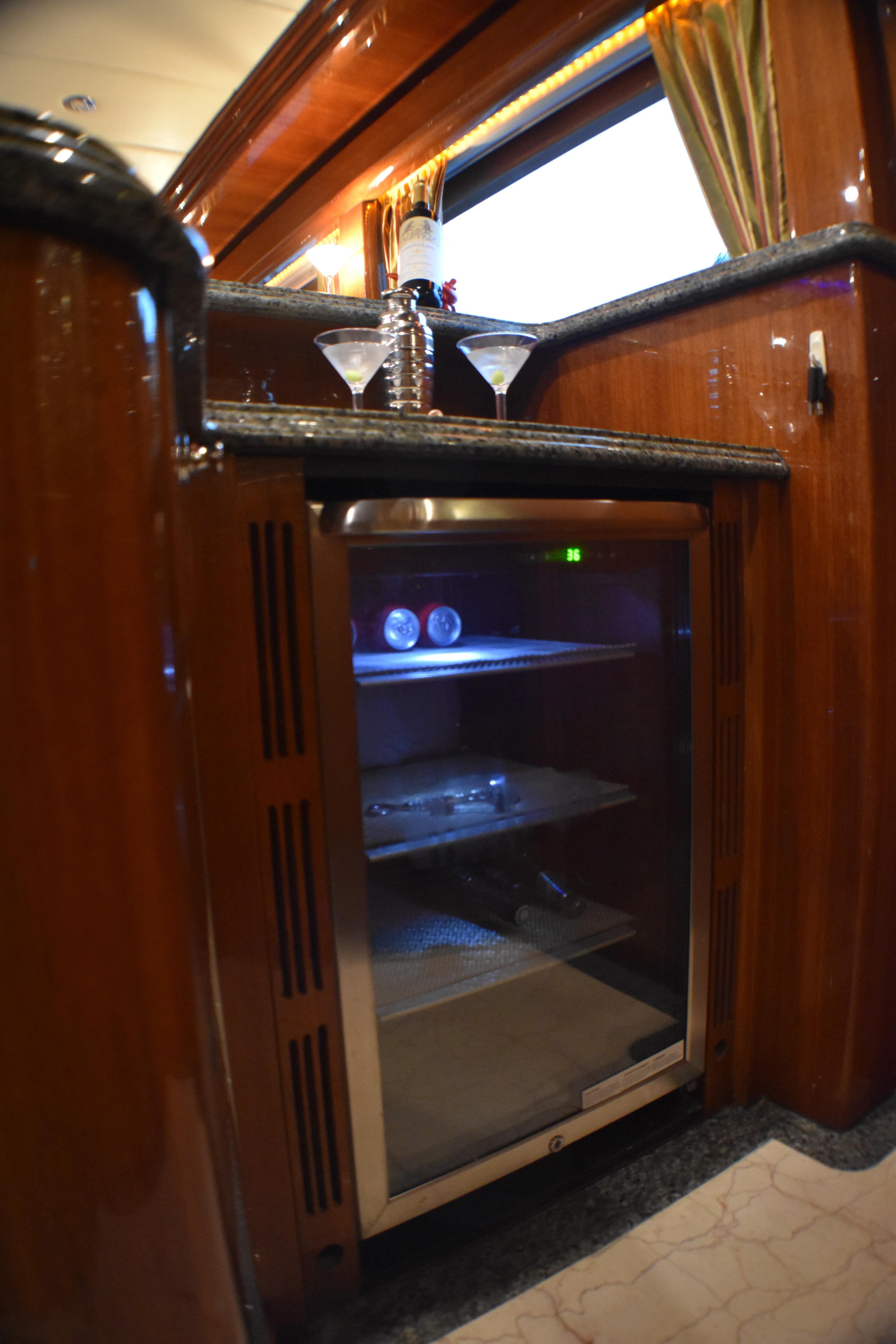 Luxurious 2006 Johnson Country Kitchen with elegant wooden cabinetry and built-in mini fridge.