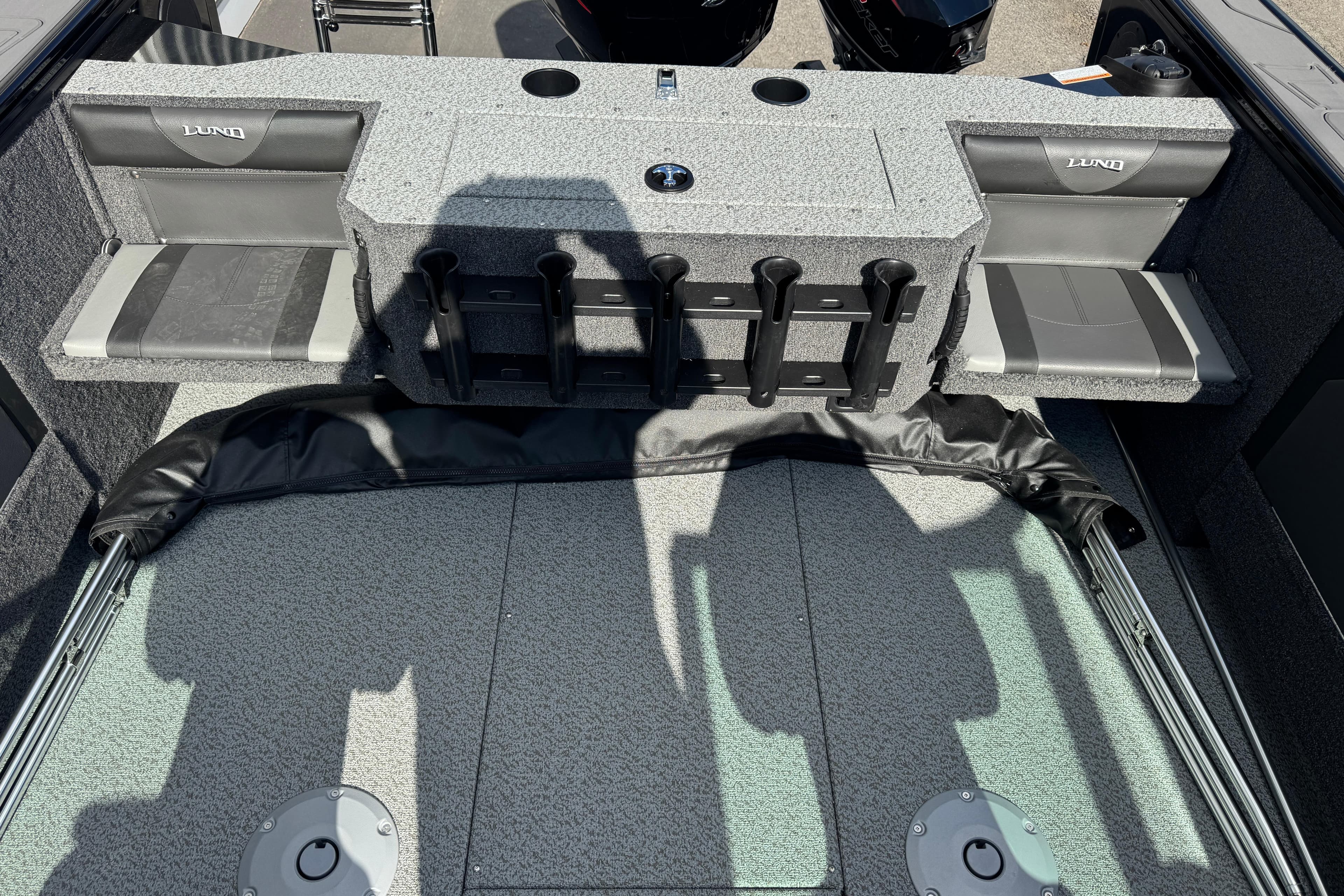 2026 Lund 1875 Fisherman boat interior with seating and rod holders.