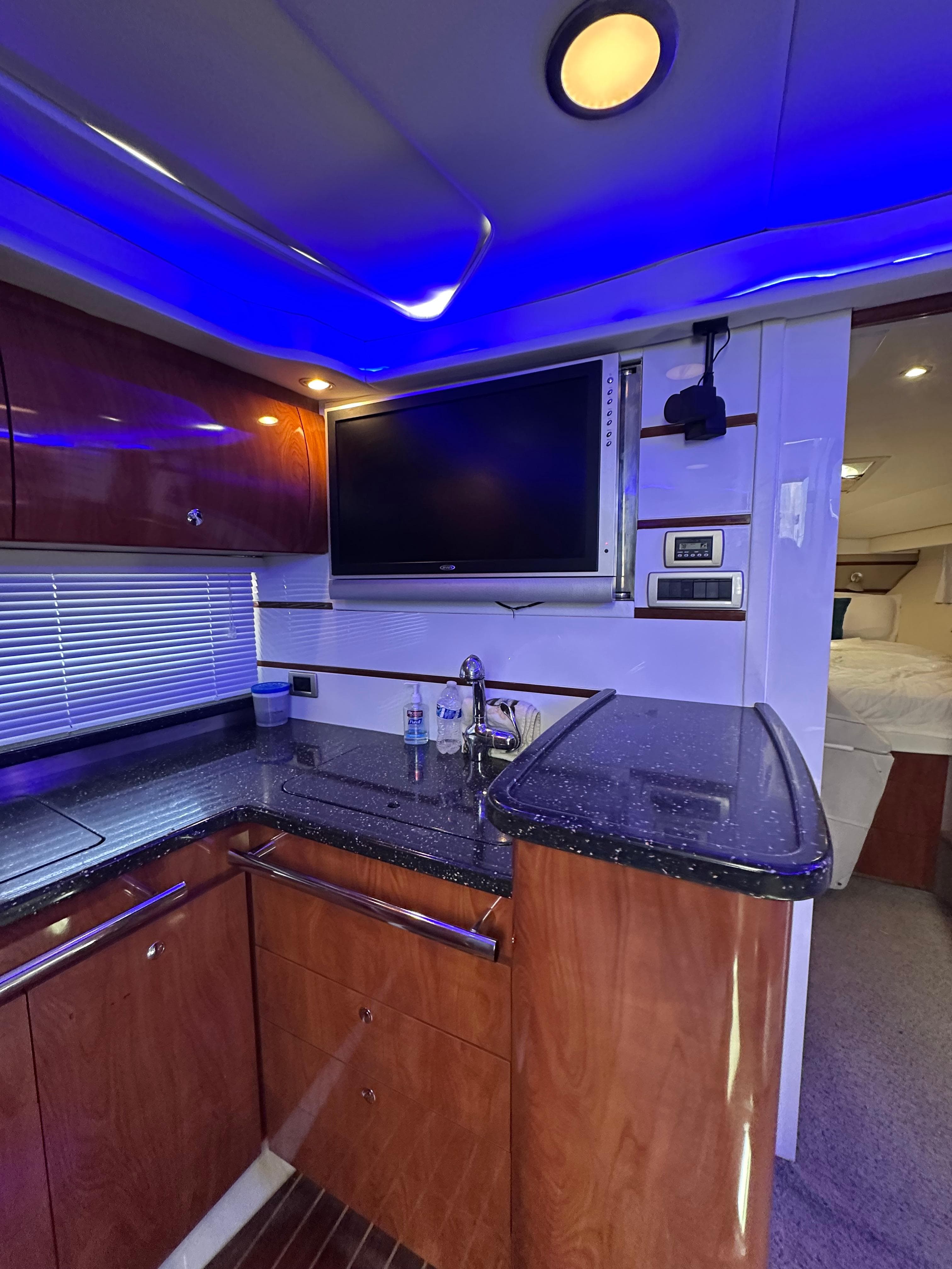 Luxurious 2008 Four Winns V458 yacht interior with modern kitchen and ambient lighting.