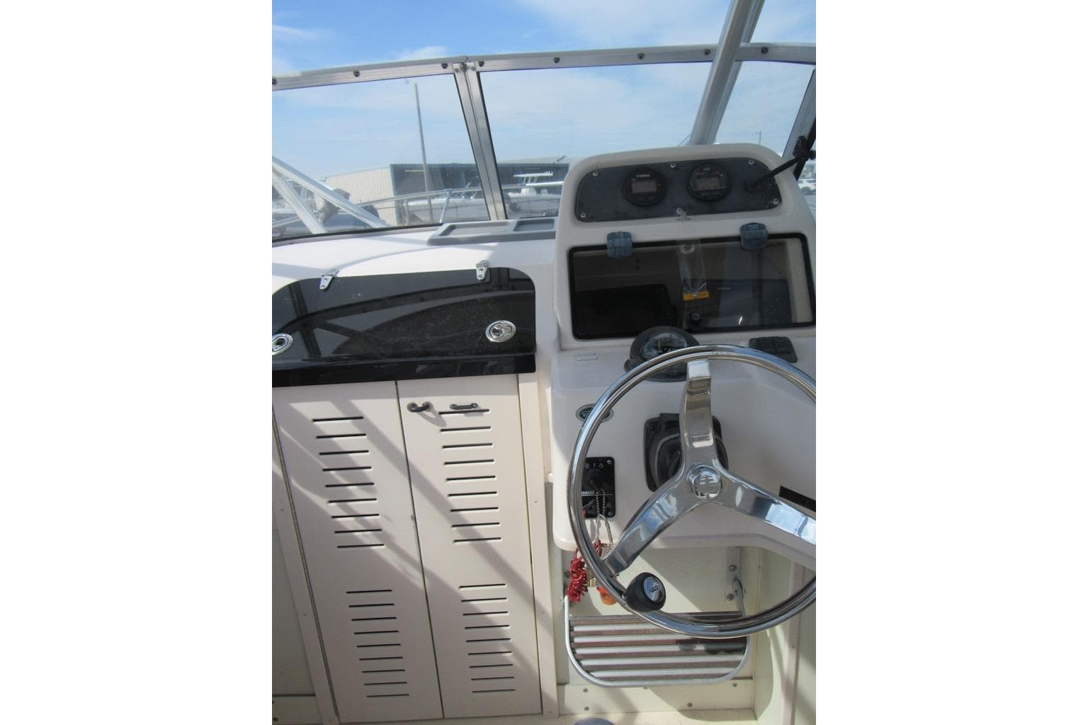 2004 Grady-White Seafarer 228 boat helm with steering wheel and instrument panel.