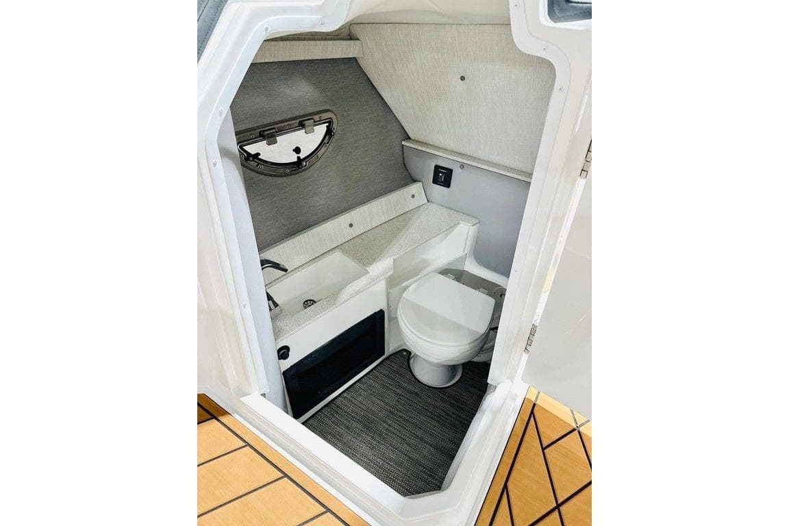 2026 Cobalt R6 Outboard boat interior bathroom with modern amenities and sleek design.