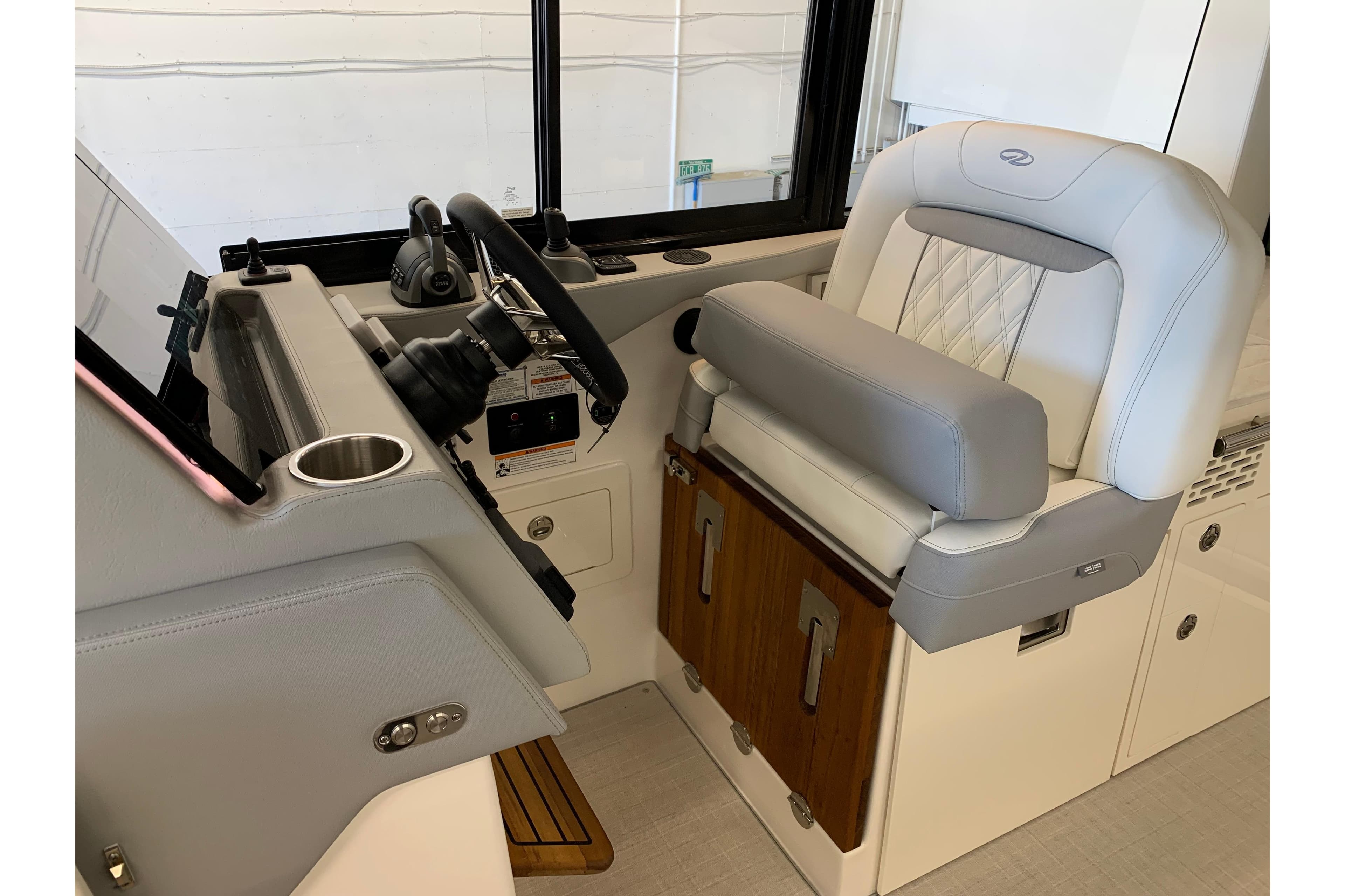2024 Regal 36 Grande Coupe helm with luxurious seating and modern controls.