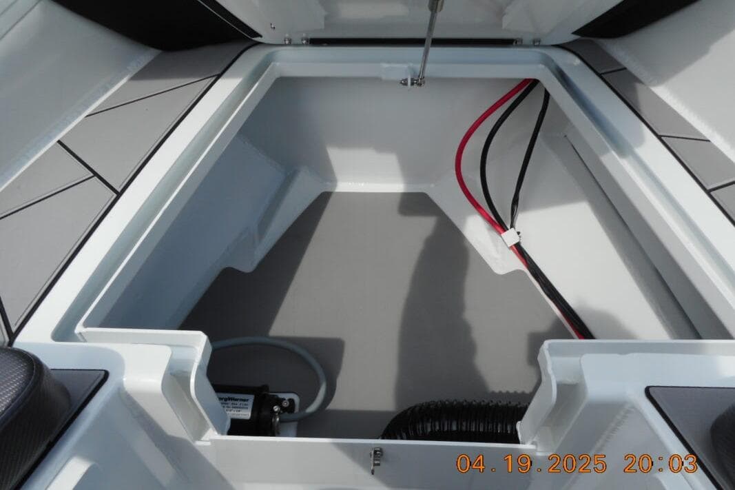 Open storage compartment of 2025 Highfield Sport 760 boat, featuring clean interior and wiring.