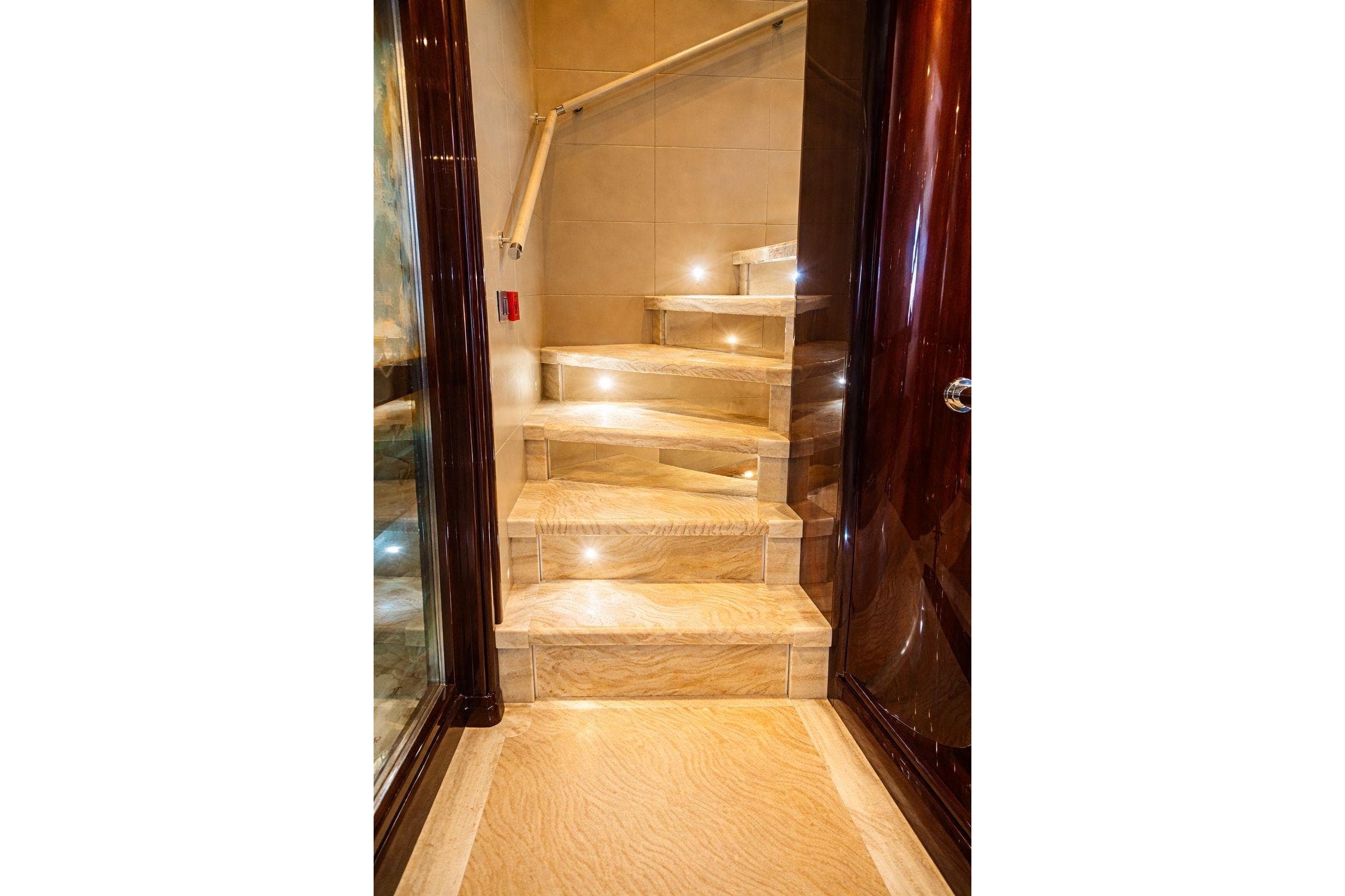 Luxurious yacht interior staircase with elegant lighting, Riviera 2010 model.
