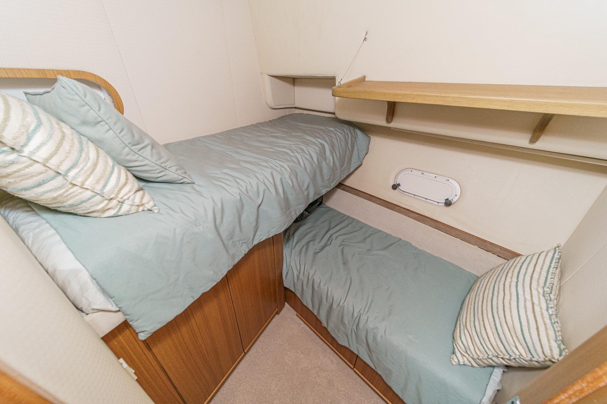 Cozy twin cabin in 2000 Bayliner 5788 Pilot House Motoryacht with striped pillows.
