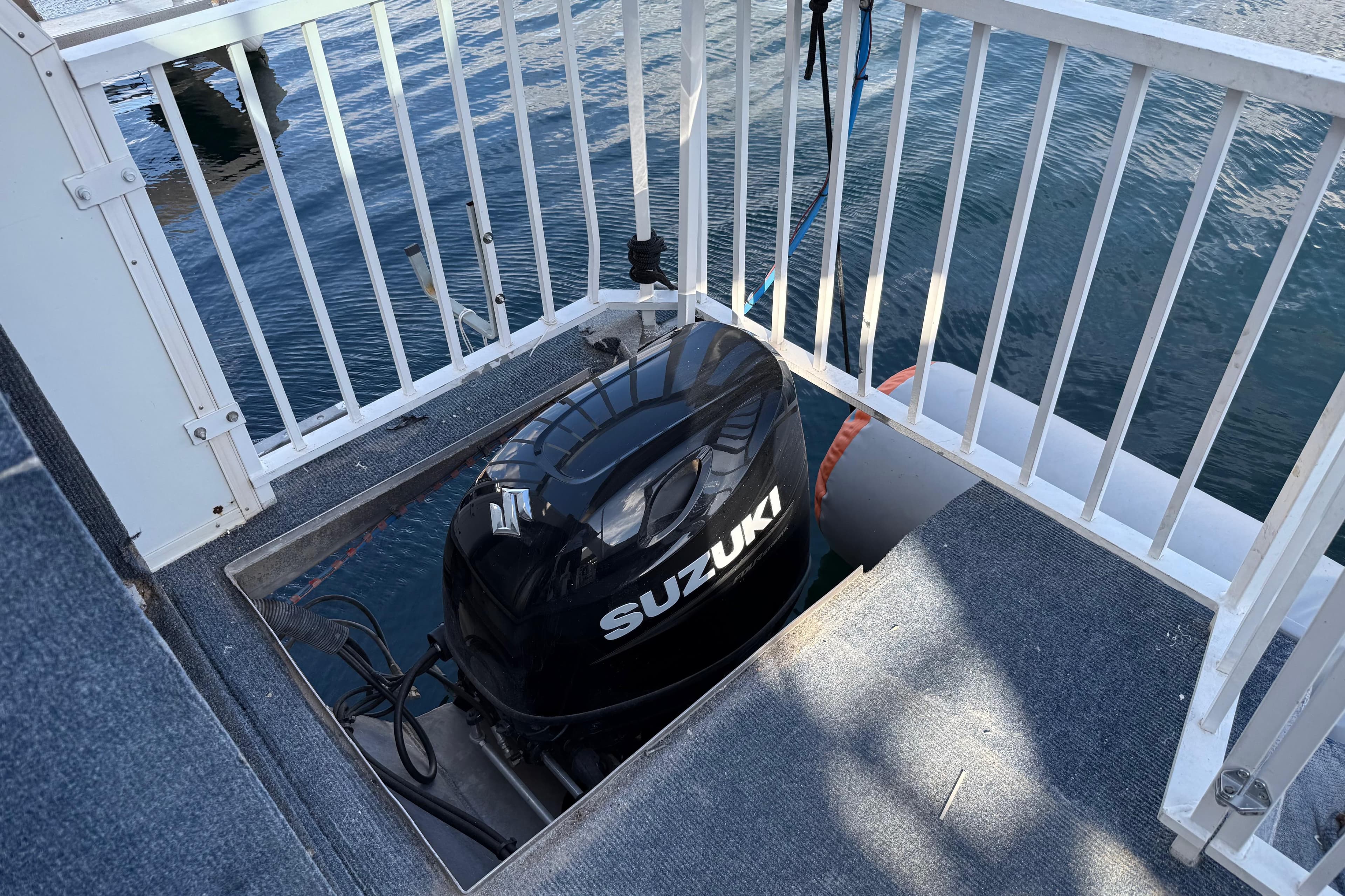 Outboard motor on 2006 Fun Country 5014 SunCountry Arizona Edition boat, docked on water.