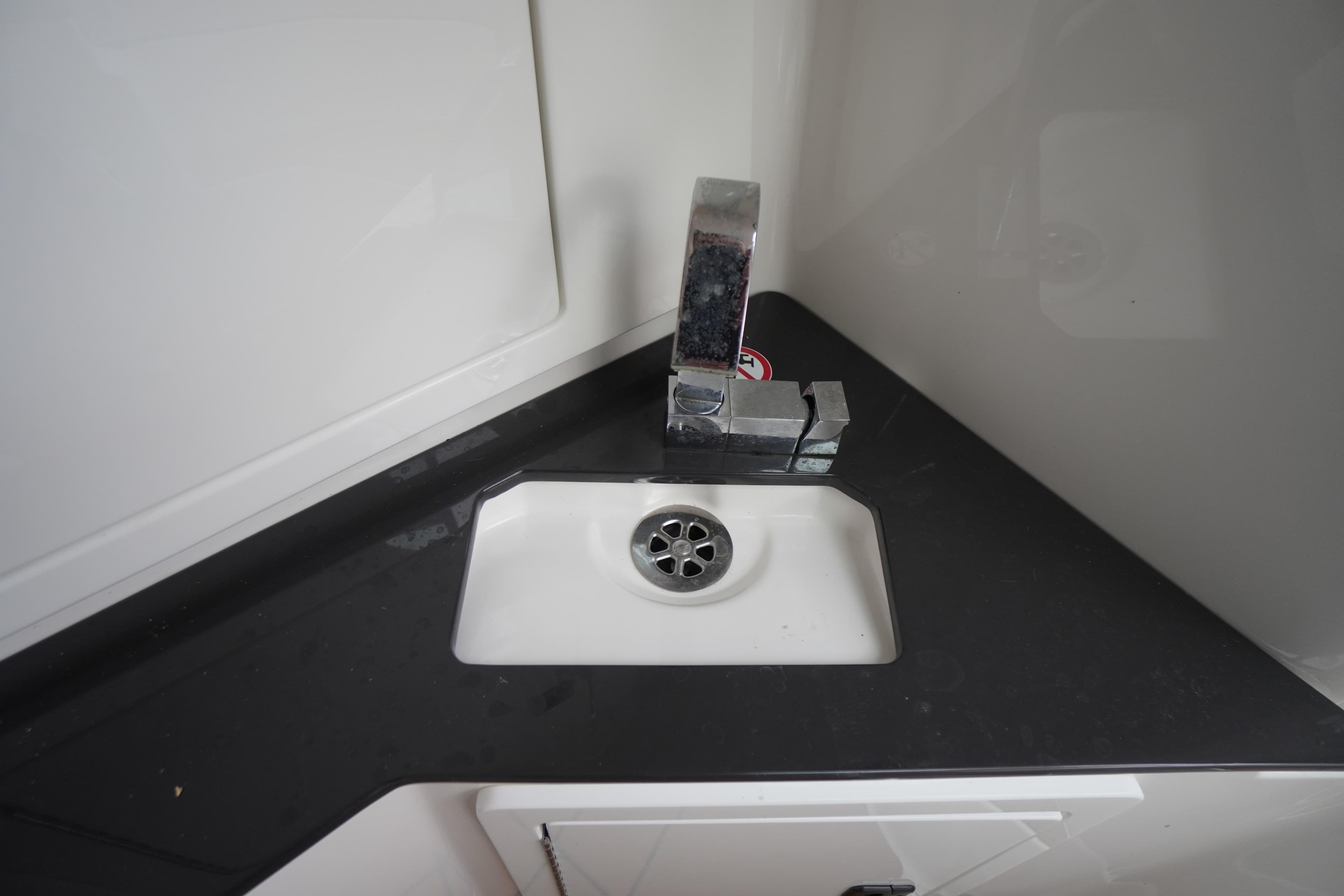 Compact sink with modern faucet in 2020 Aviara AV32 OB boat.