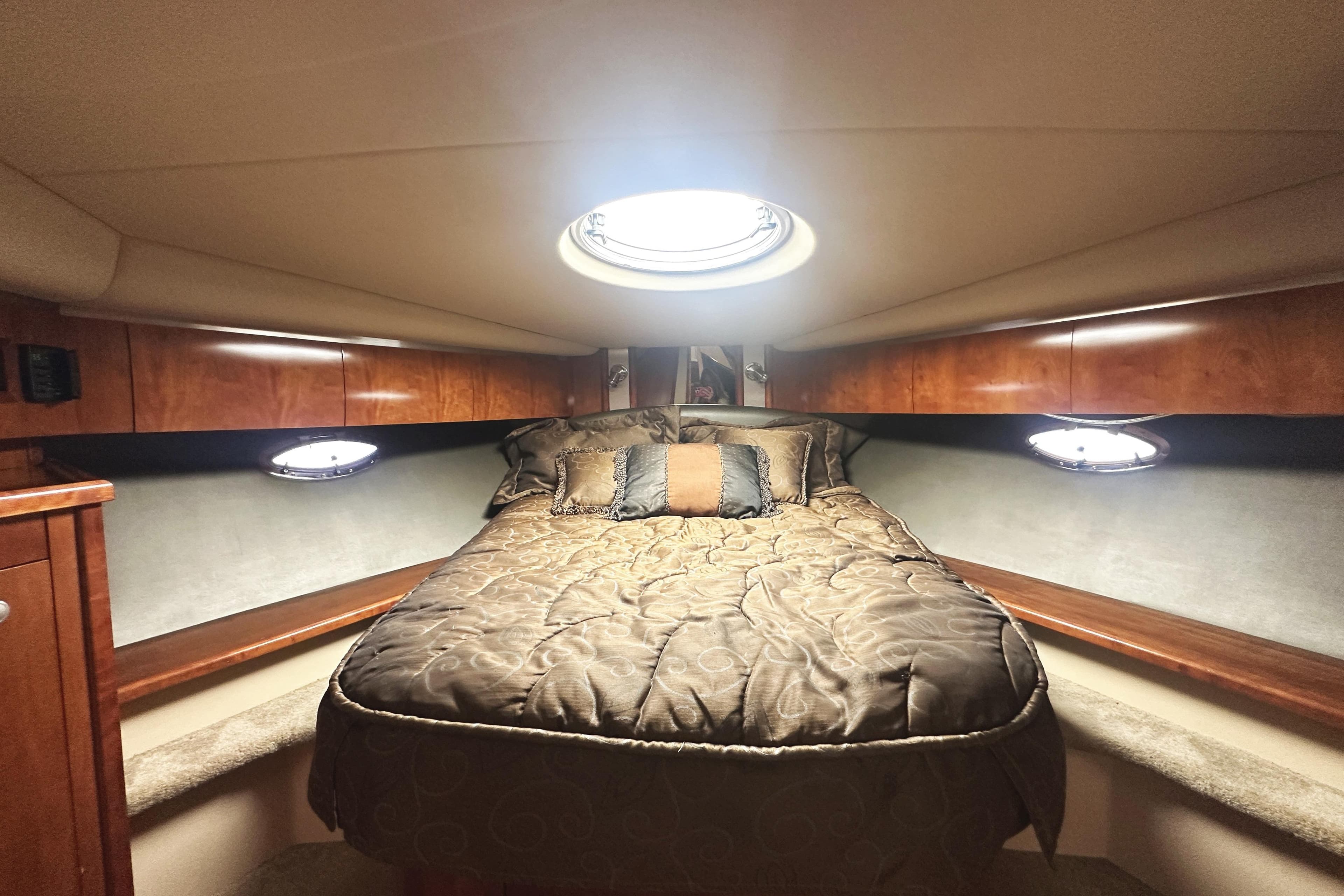 Luxurious cabin interior of 2007 Cruisers Yachts 540 Express with cozy bedding.